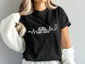 Black t-shirt with white "TRAVEL NURSE" text, a camper, and a stethoscope.