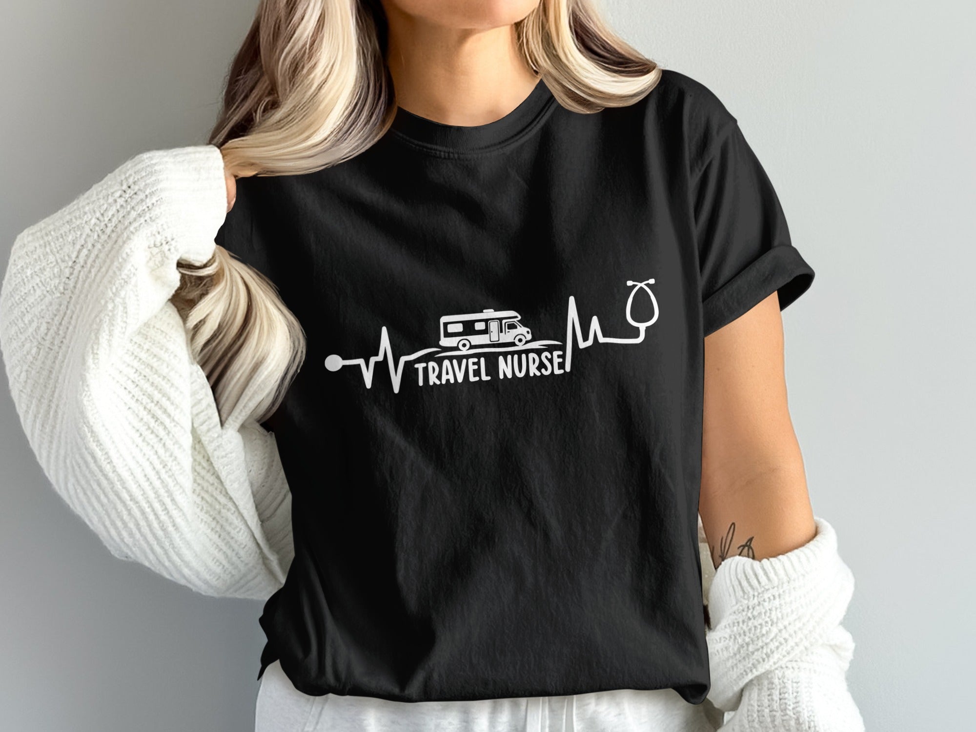 Black t-shirt with white "TRAVEL NURSE" text, a camper, and a stethoscope.