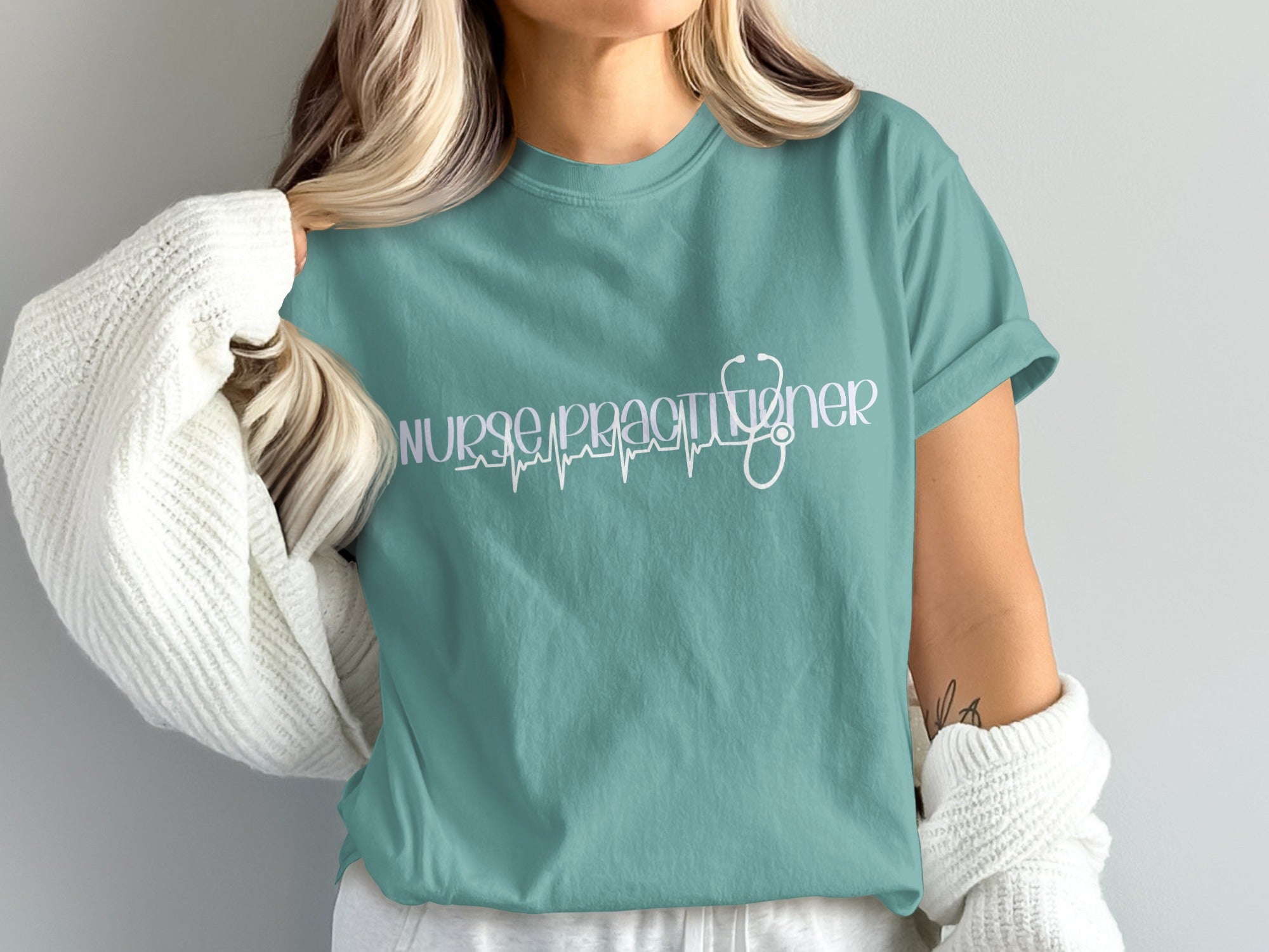 Teal t-shirt with "Nurse Practitioner" text and a stethoscope graphic.