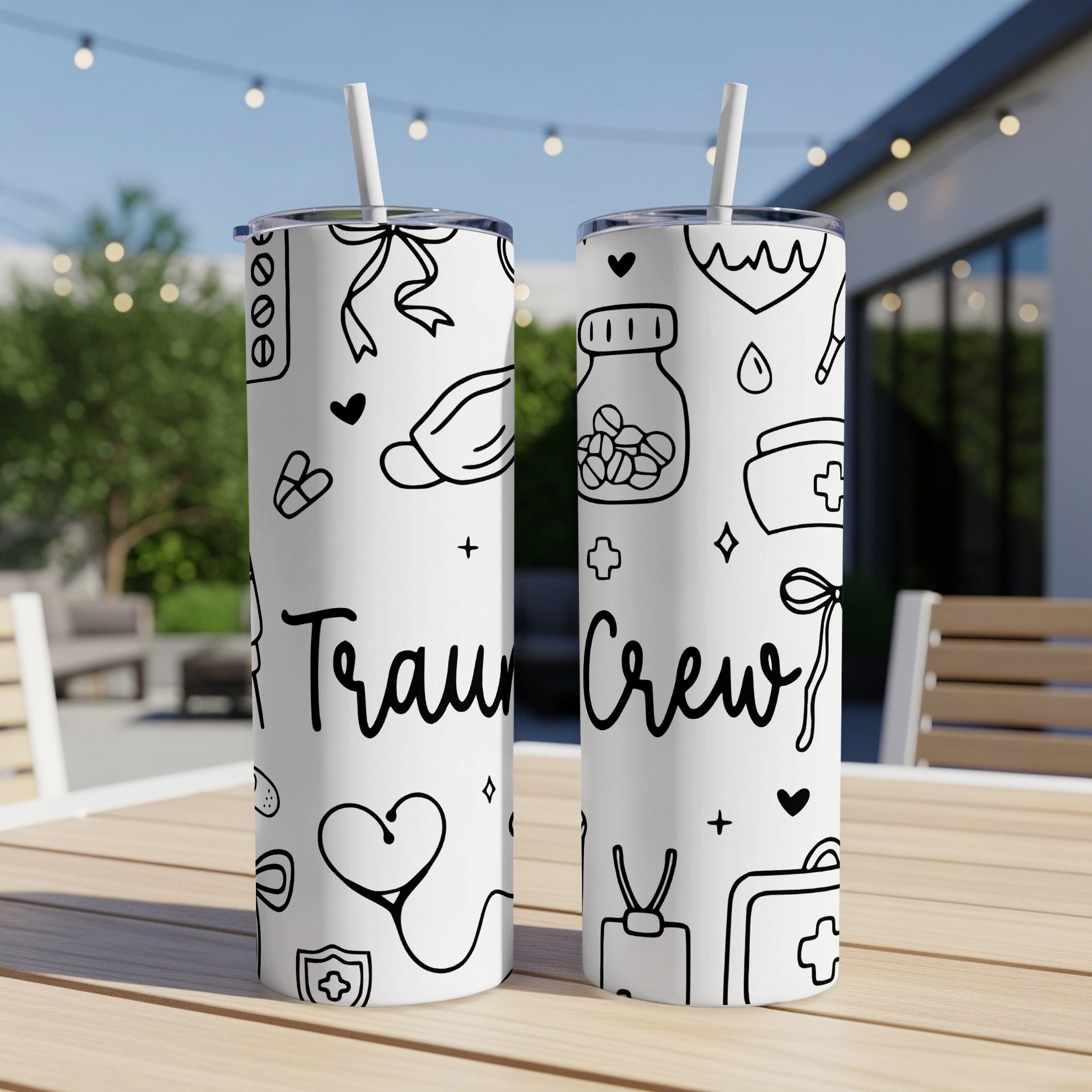 White tumbler with medical icons and "Traum Crew" text.