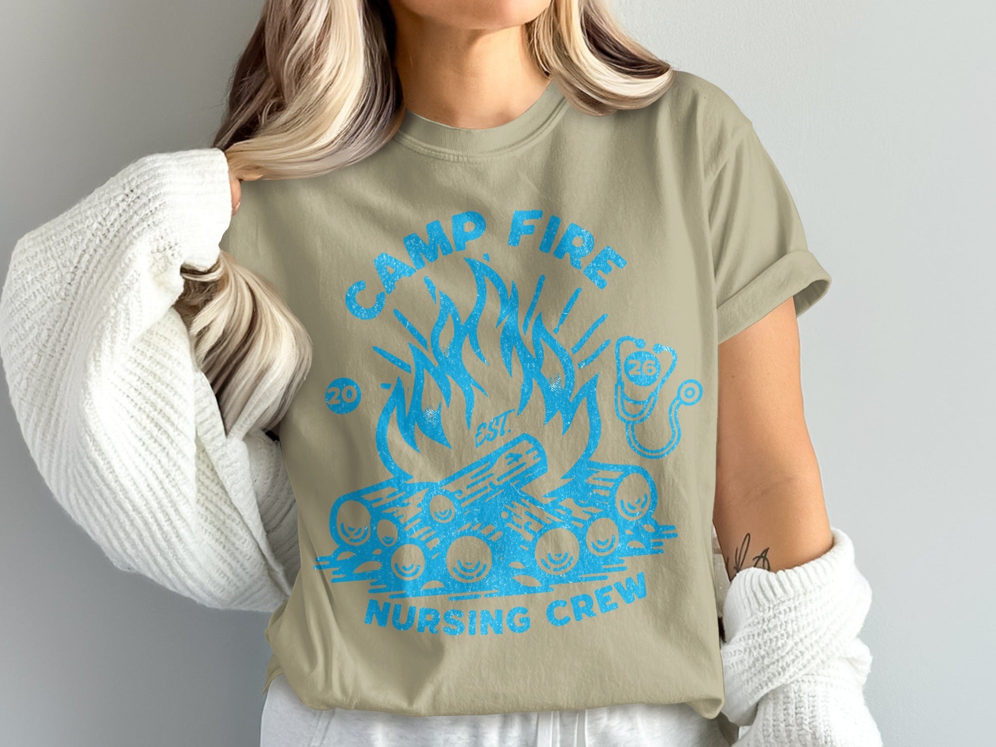 Tan t-shirt with blue campfire and "Camp Fire Nursing Crew" text.