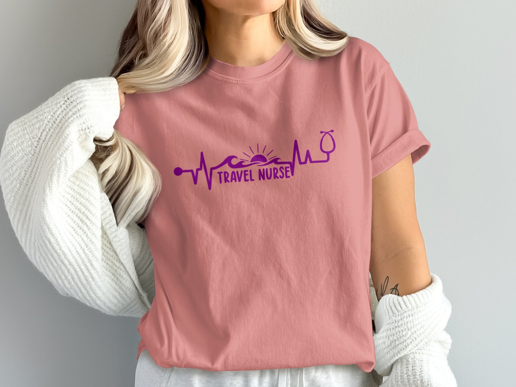 Pink t-shirt with "Travel Nurse" text and heartbeat graphic.