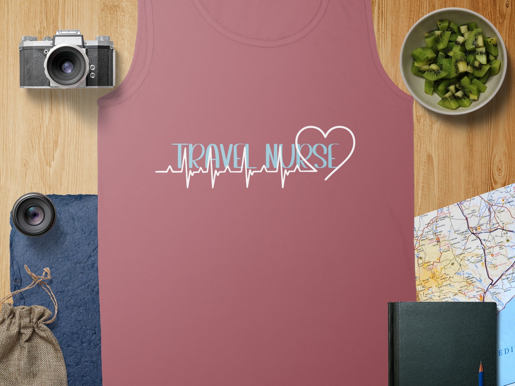 Tank top with "Travel Nurse" heartbeat graphic and a notebook.