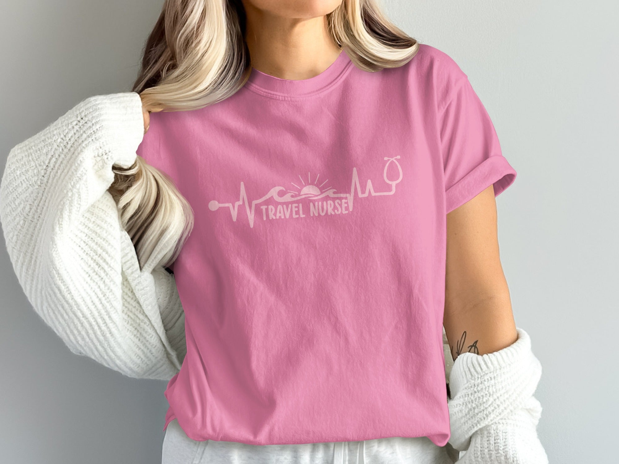 Pink t-shirt with "Travel Nurse" text and heartbeat graphic.