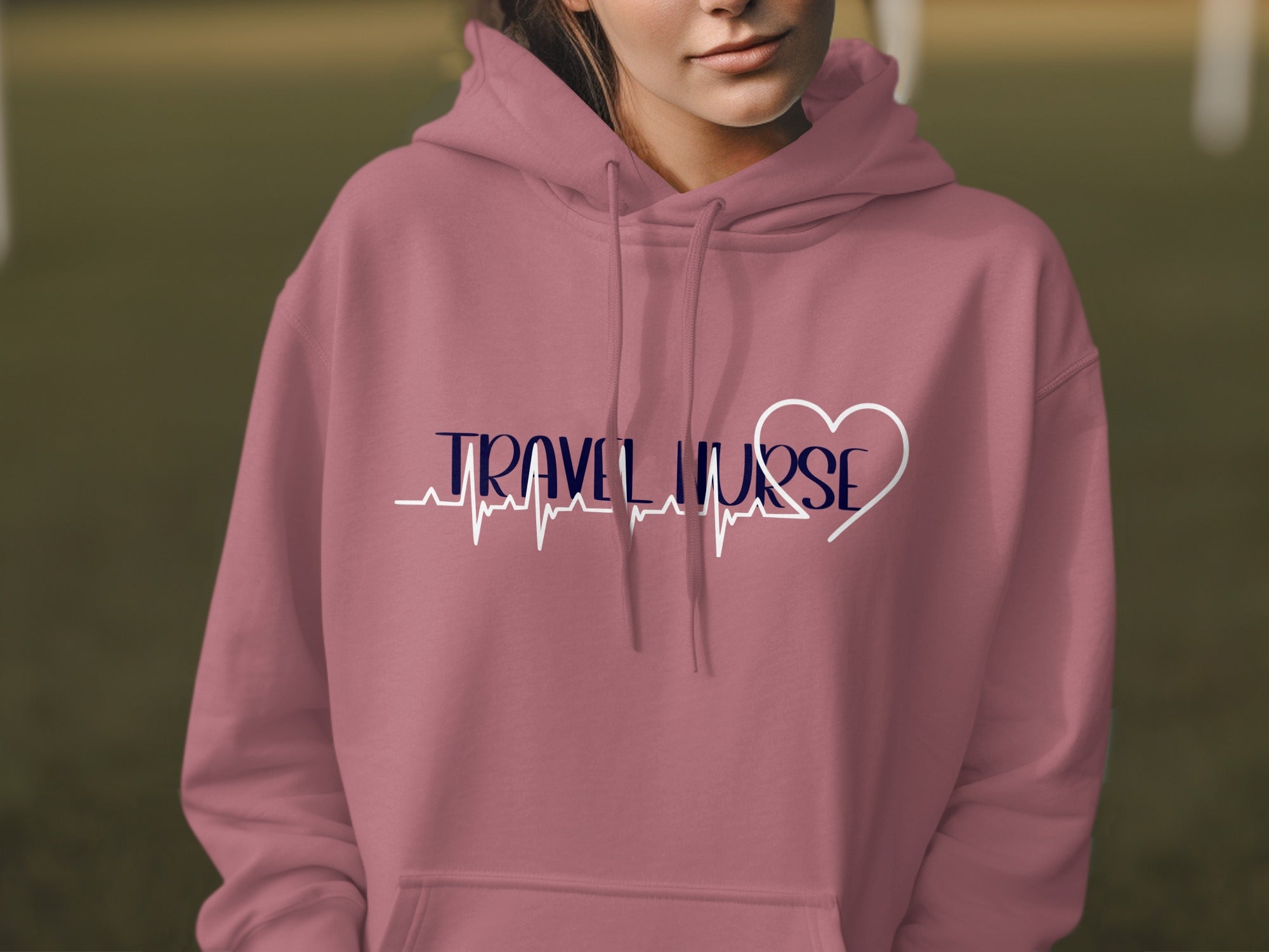 Pink hoodie with "Travel Nurse" text and a heart-shaped ECG line.
