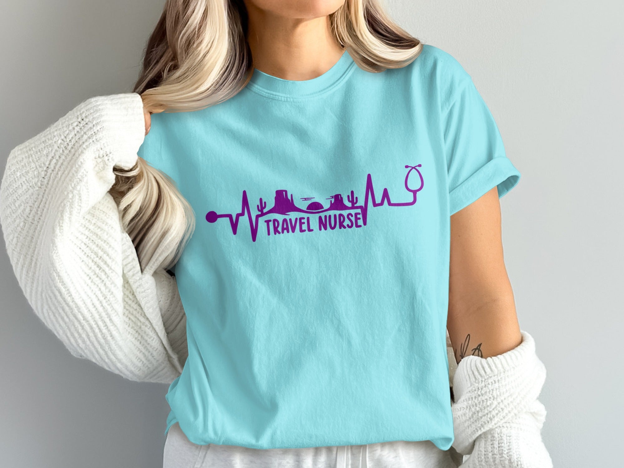 Teal t-shirt with purple heartbeat graphic and "TRAVEL NURSE" text.