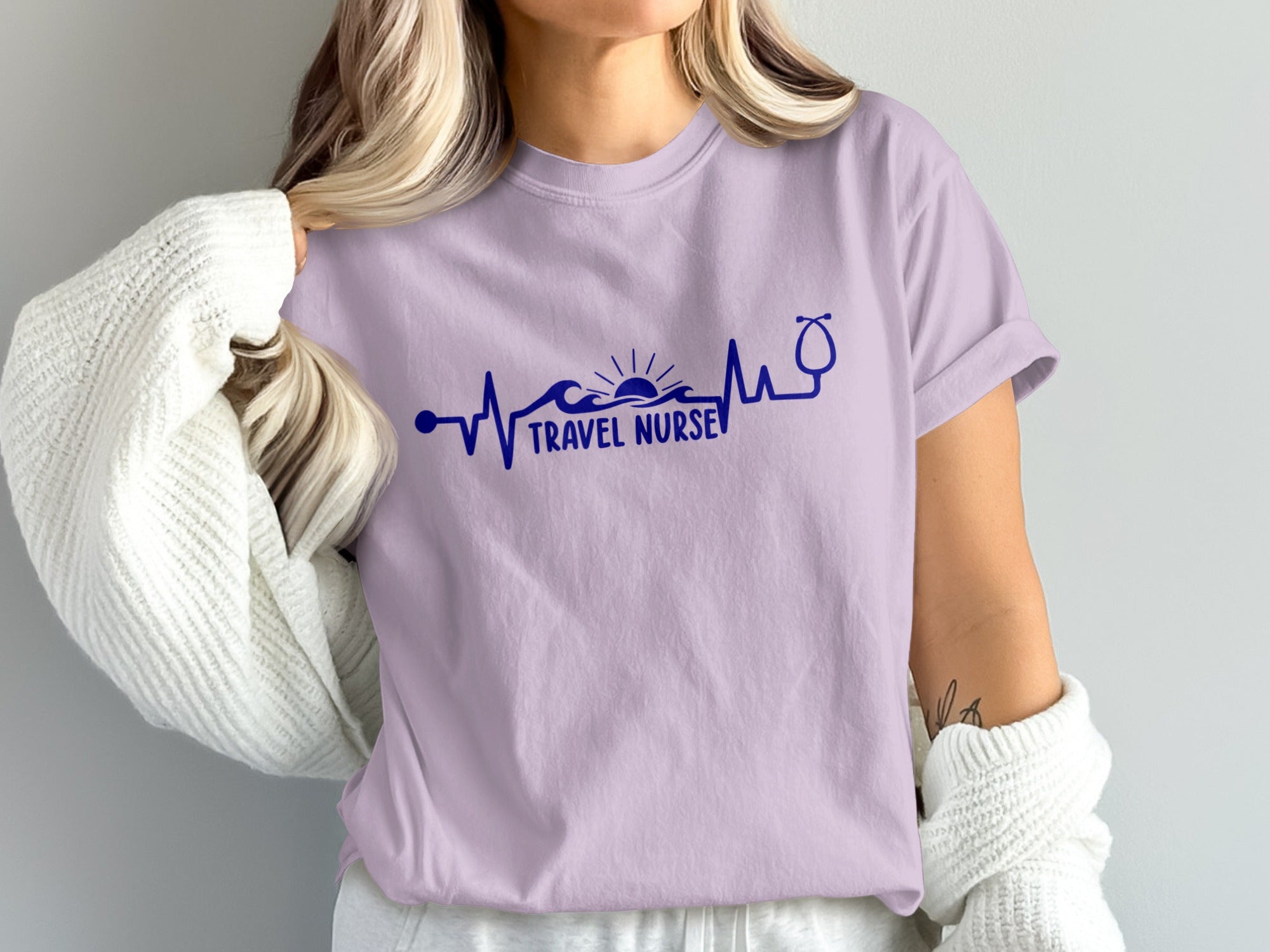 Light purple t-shirt with navy blue travel nurse heartbeat graphic.