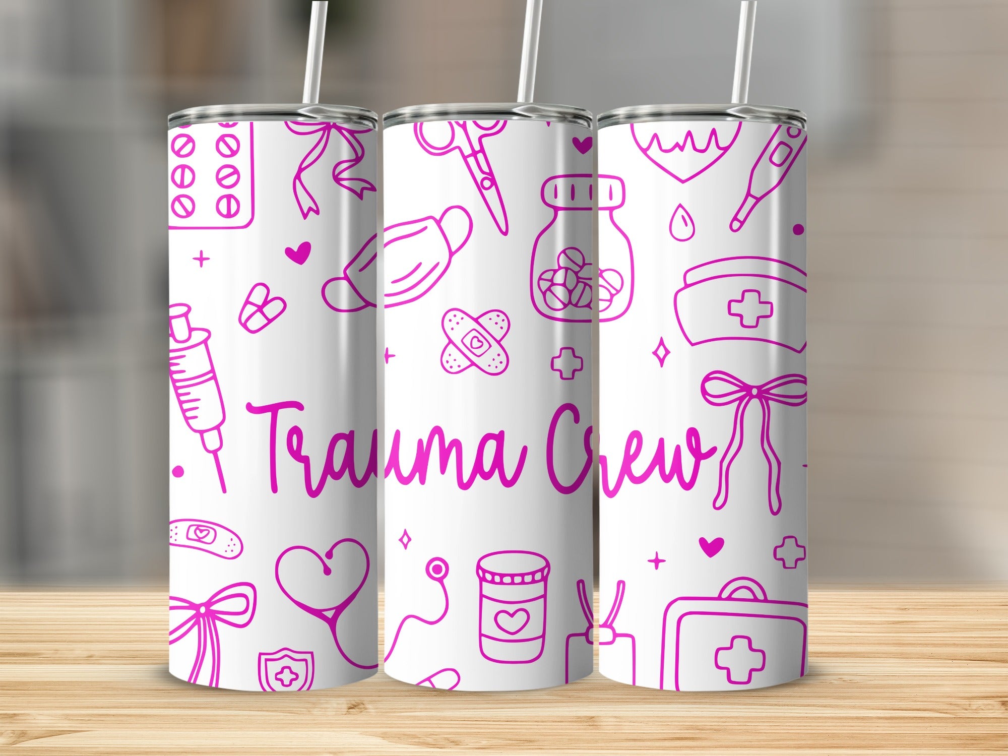 Pink outline drawings of medical items and "Trauma Crew" text on three tumblers.
