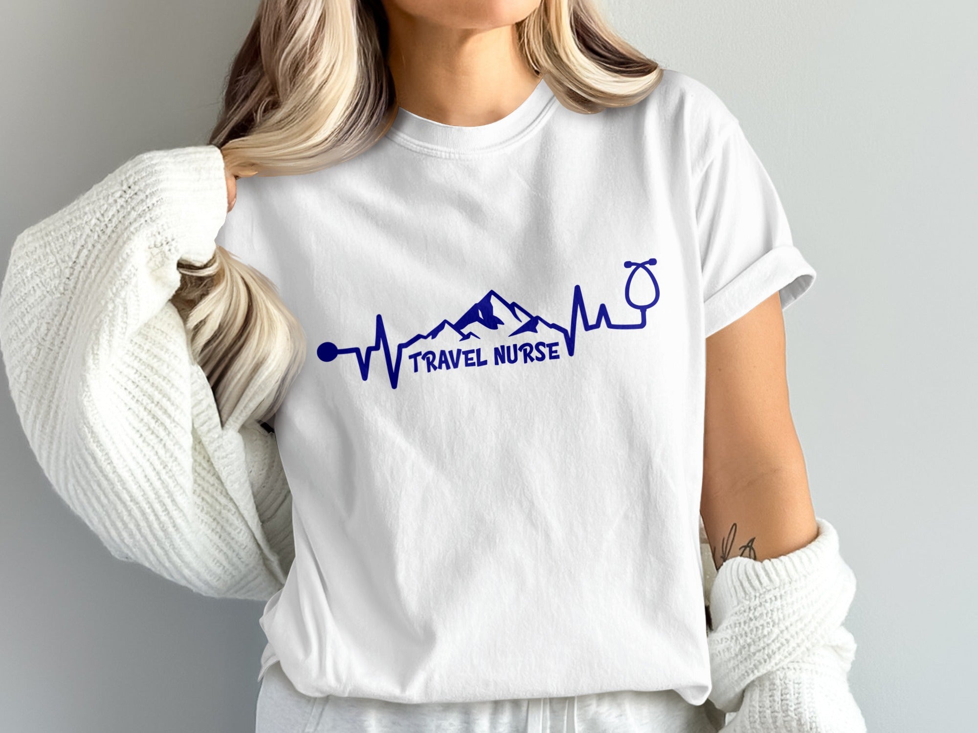 White t-shirt with navy blue mountain heartbeat and stethoscope design.