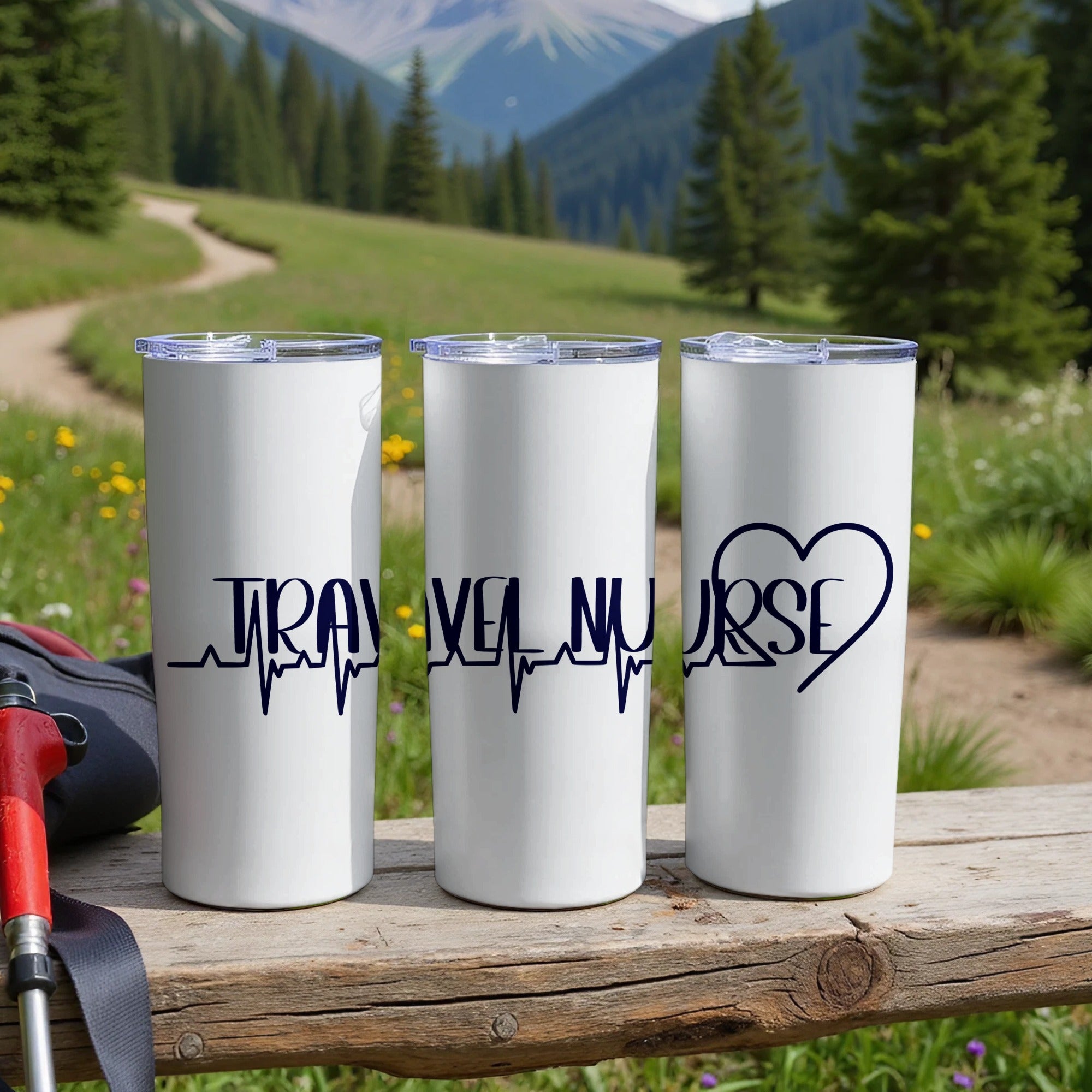 Three white travel nurse tumblers with blue electrocardiogram and heart designs.