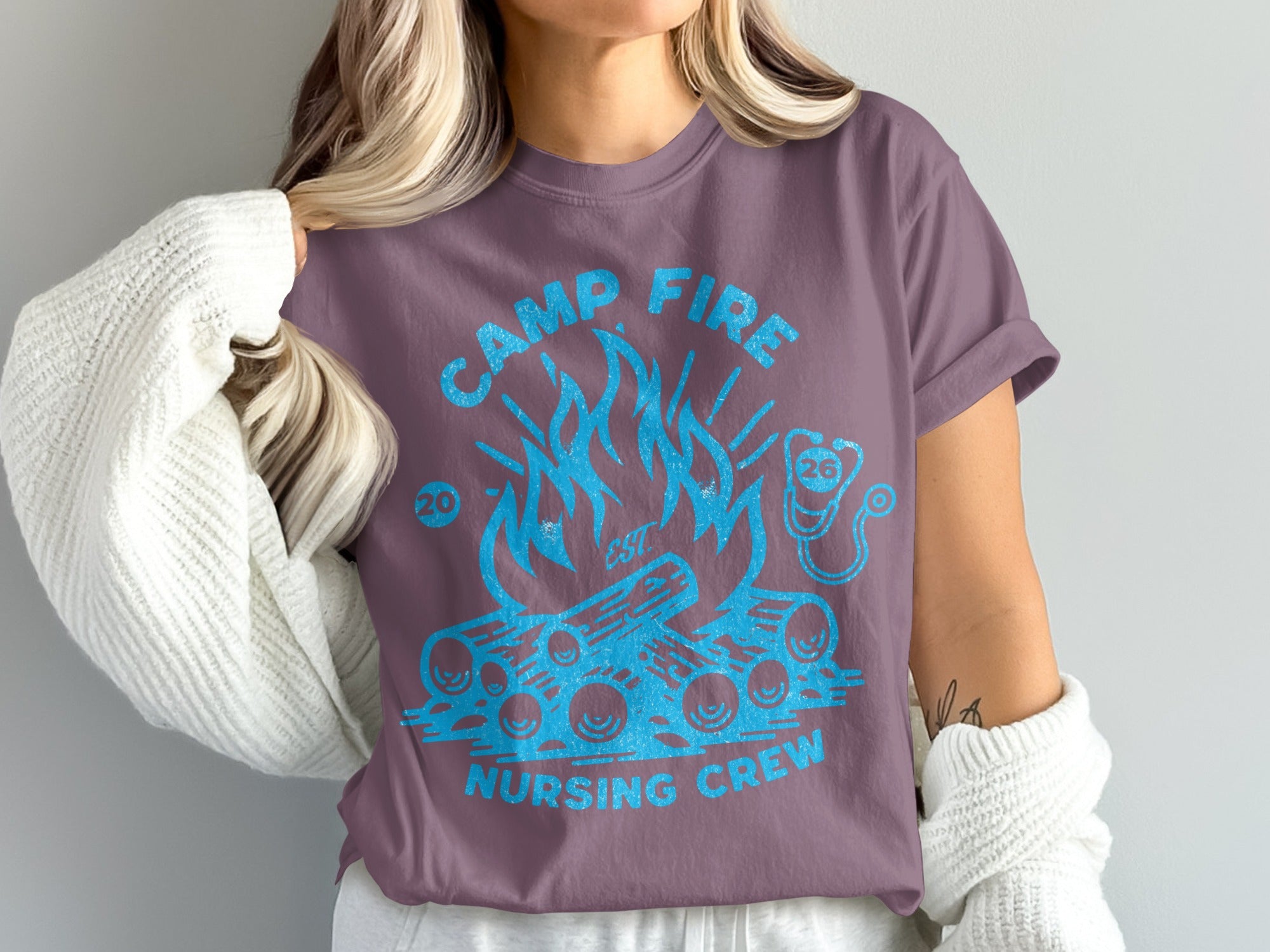 Purple t-shirt with campfire and "CAMP FIRE NURSING CREW" text.