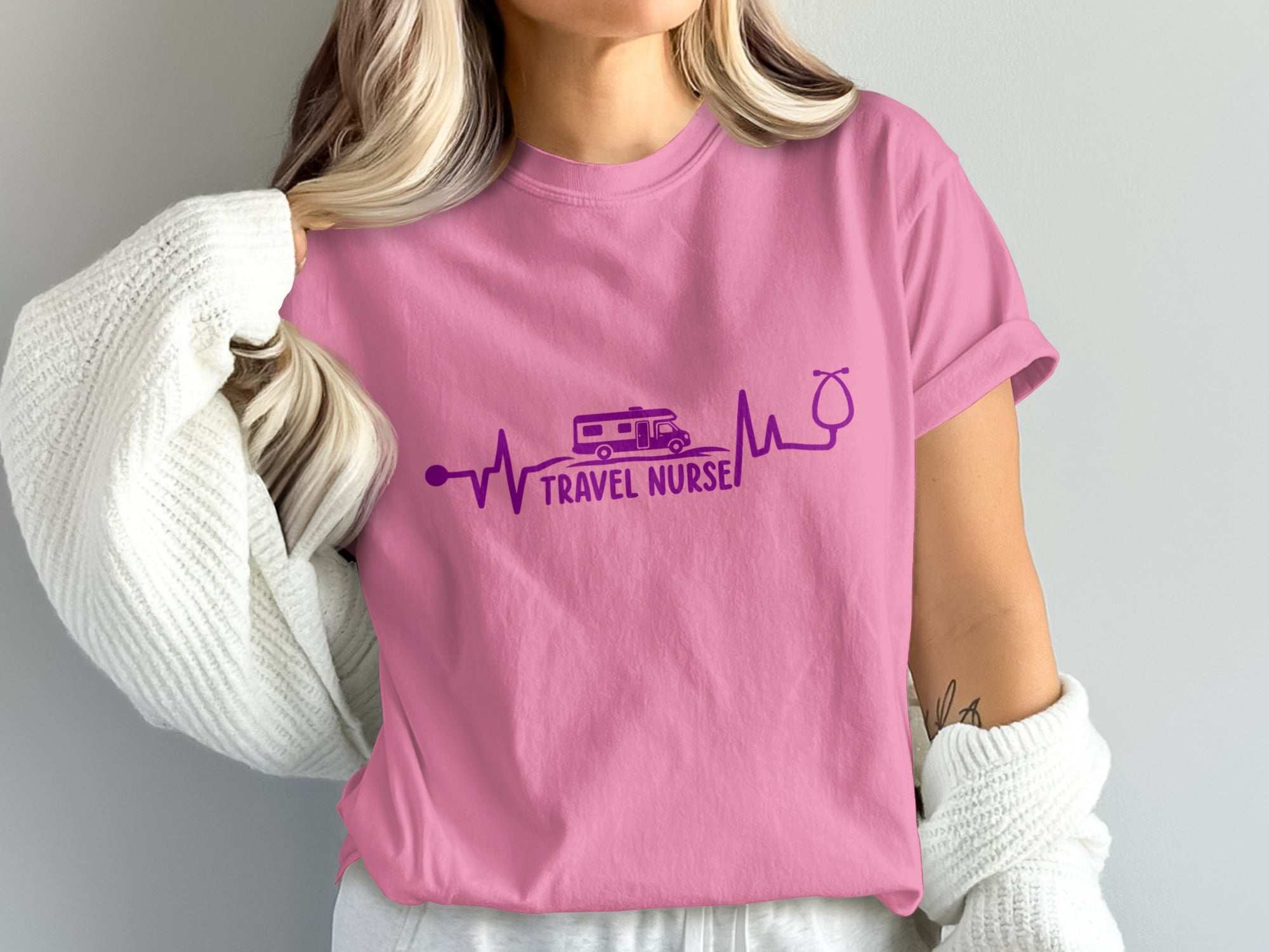 Pink t-shirt with a purple heartbeat line, camper van, and stethoscope, reading "Travel Nurse".