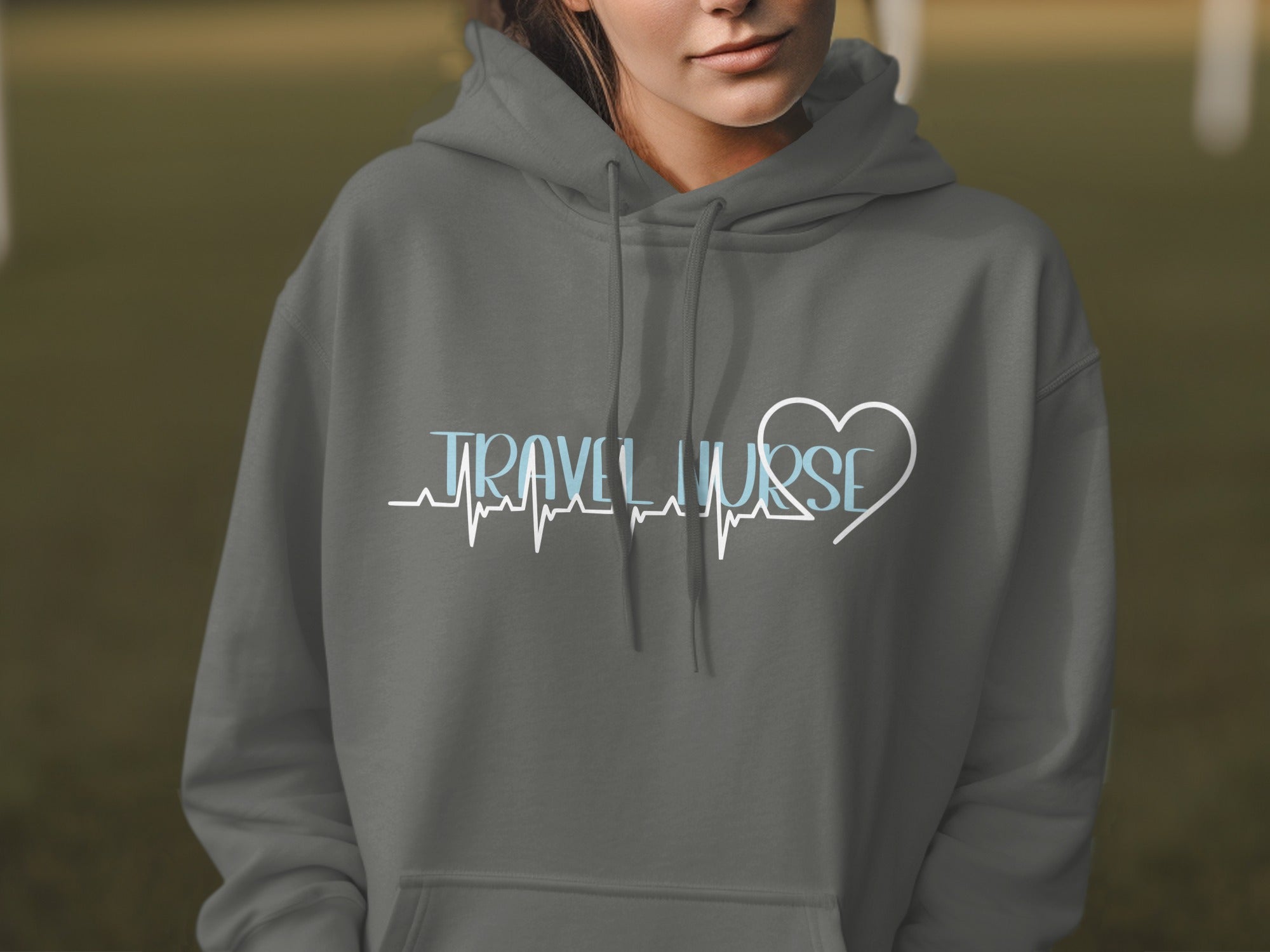Gray hoodie with "TRAVEL NURSE" text and heart heartbeat graphic.