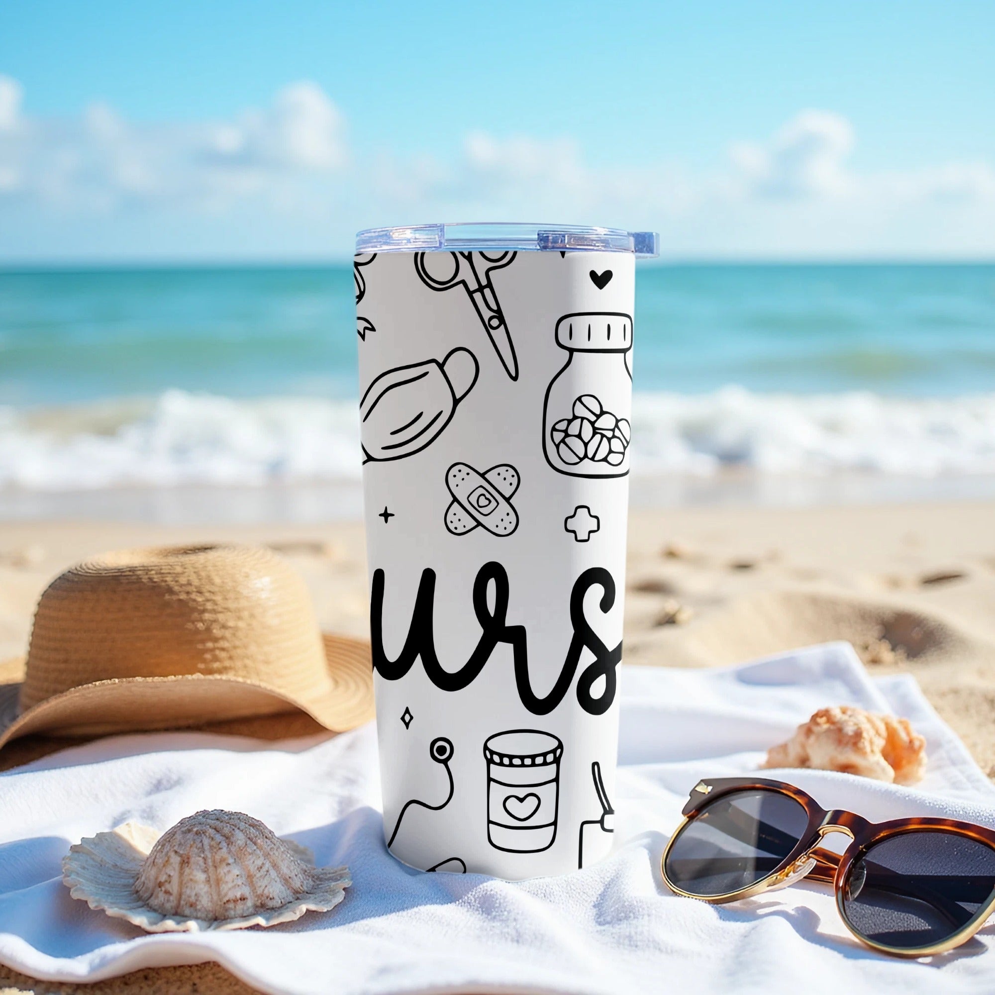 White tumbler with medical icons and "nurs" text on a beach towel.
