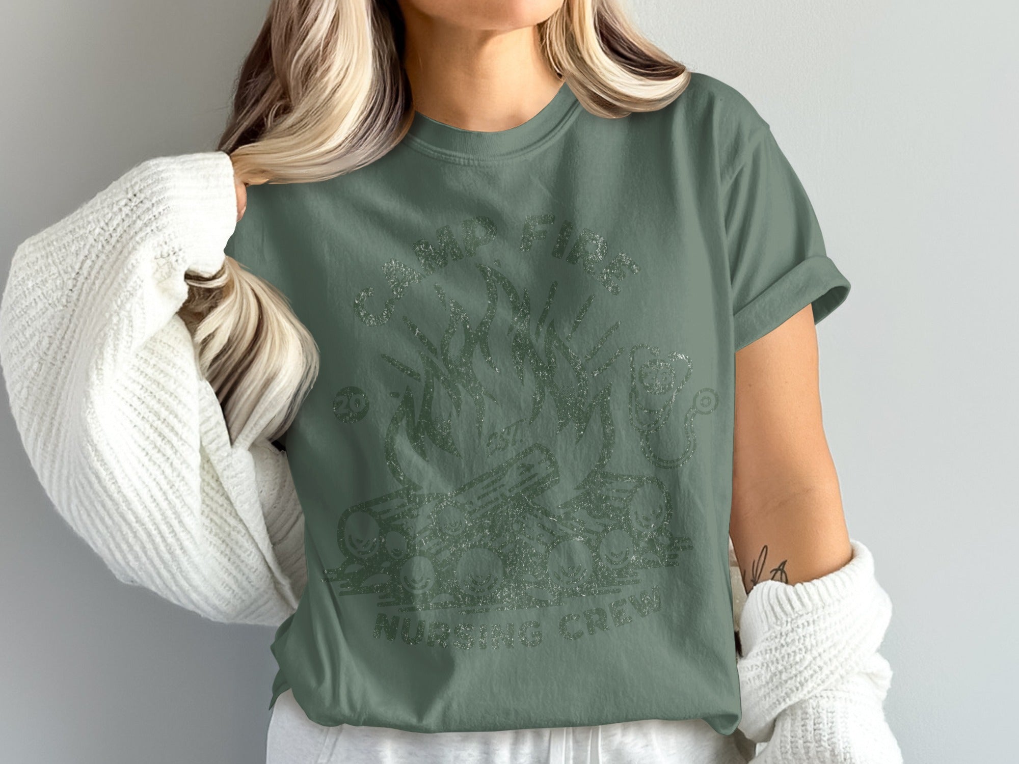 Green t-shirt with "Campfire Nursing Crew" text and campfire graphic.