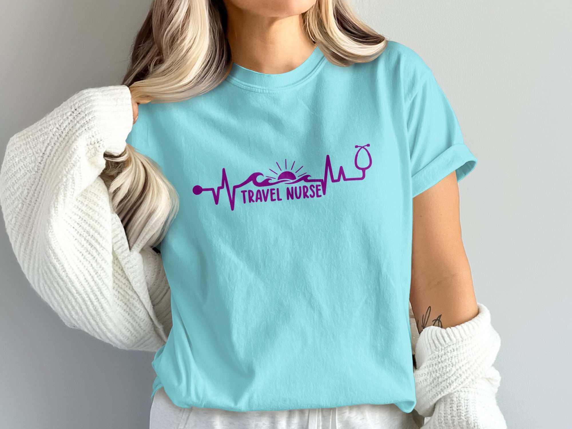 Teal t-shirt with purple heartbeat graphic of a swimmer and stethoscope.