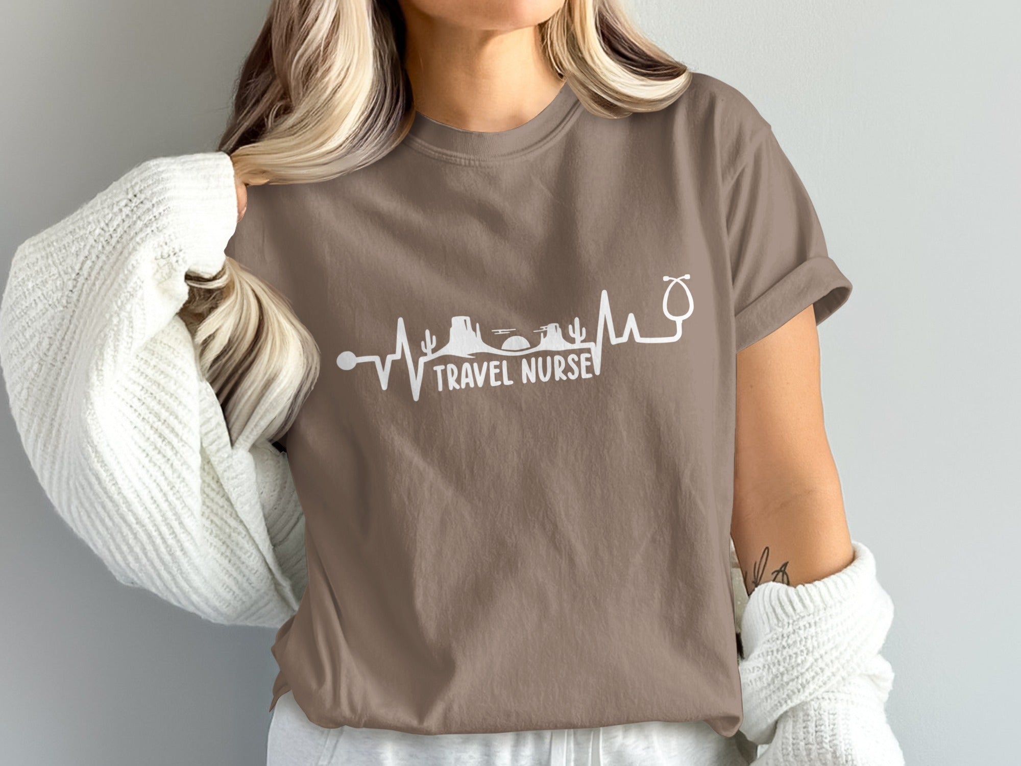 Brown t-shirt with a heartbeat line graphic and "TRAVEL NURSE" text.