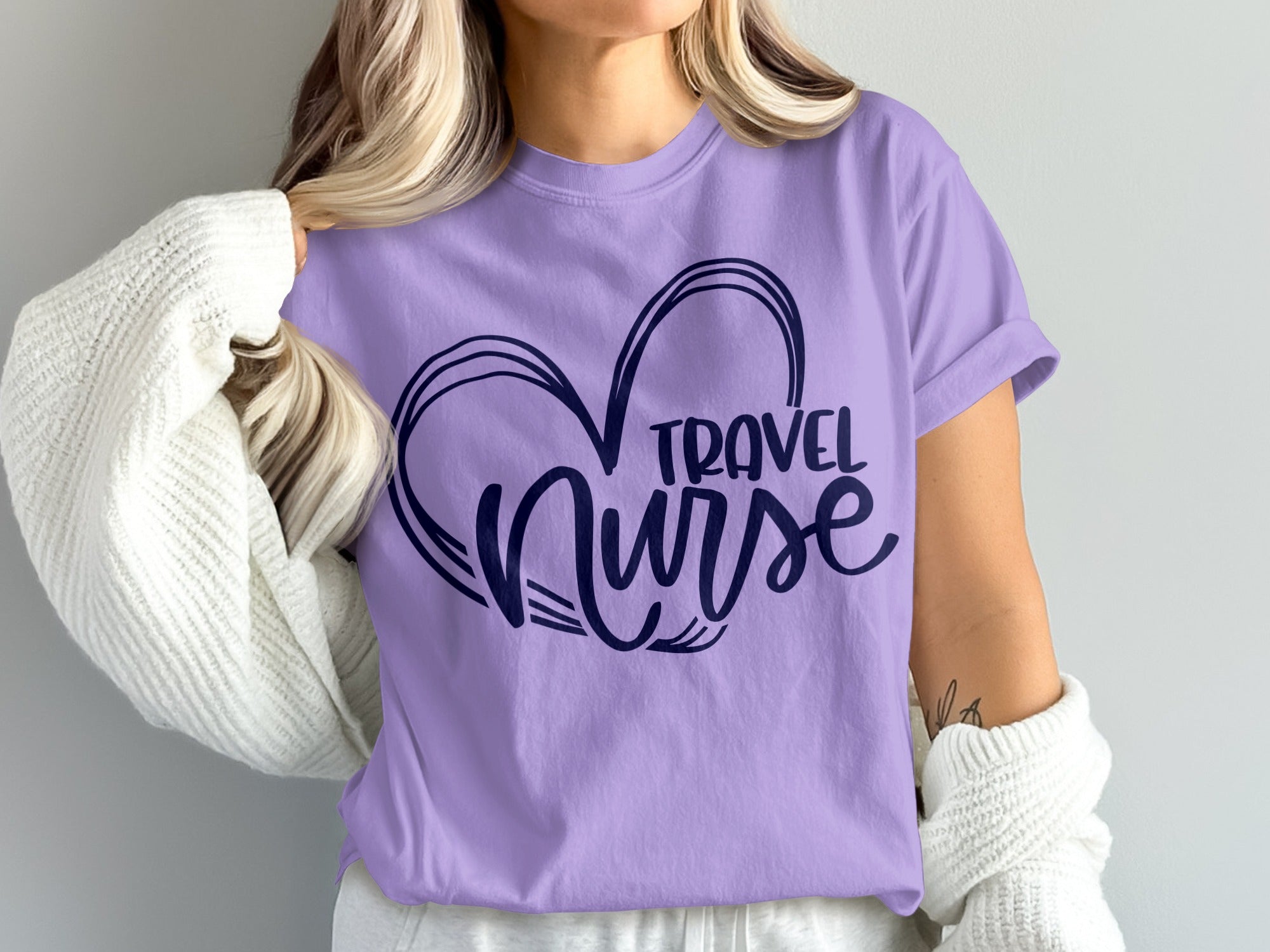 Purple t-shirt with a dark blue heart outline and "TRAVEL NURSE" text.