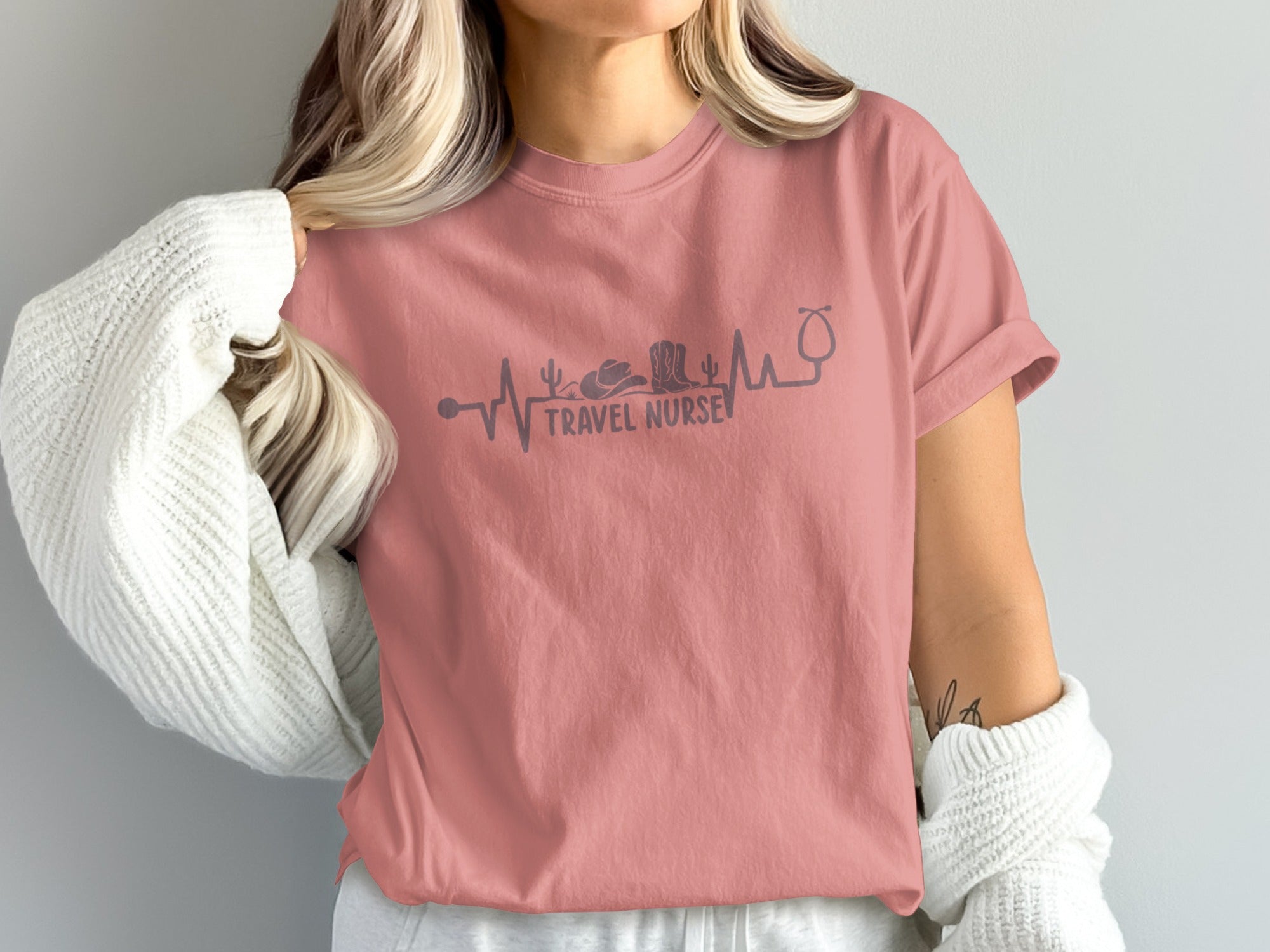 Pink t-shirt with "TRAVEL NURSE" text and medical heartbeat graphic.