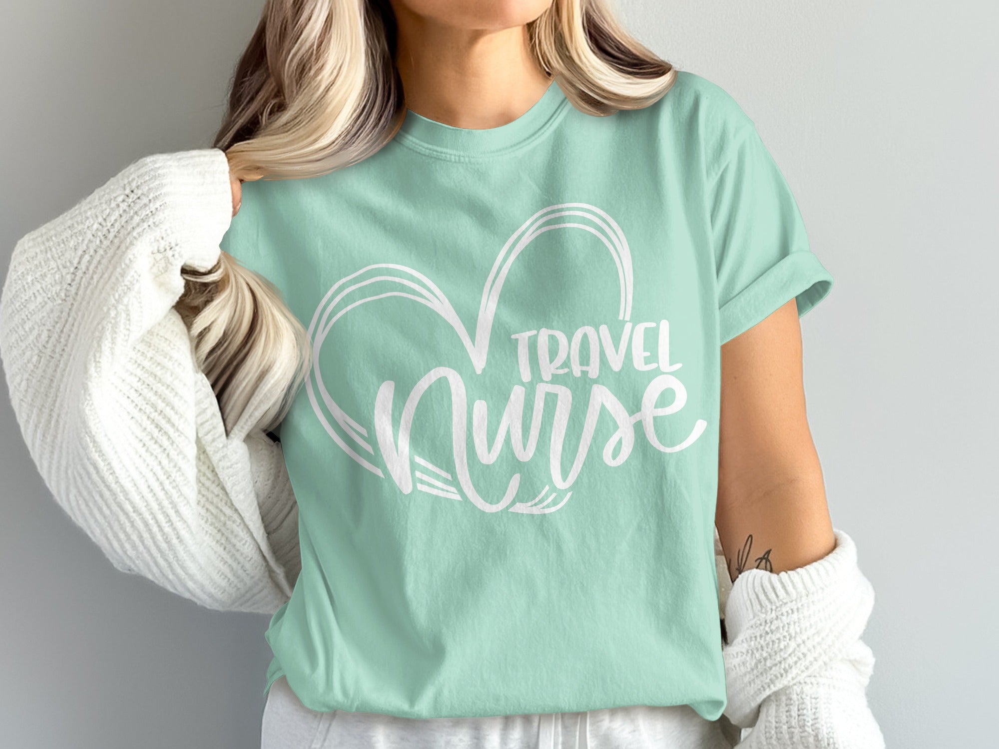 Mint t-shirt with white "Travel Nurse" text inside a heart outline.