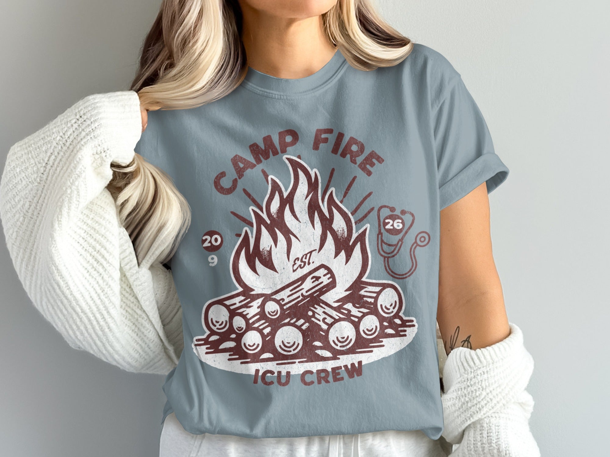 Camp Fire ICU Crew graphic on a blue t-shirt with logs and flames.