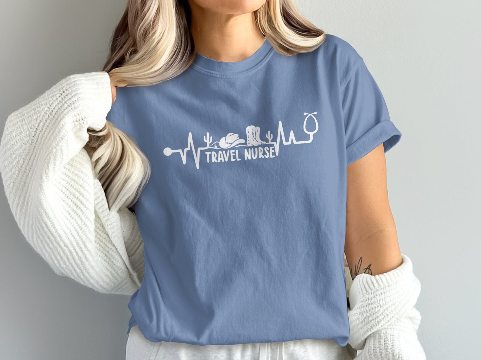 Blue t-shirt with "Travel Nurse" text and stethoscope, cactus, and cowboy boot design.
