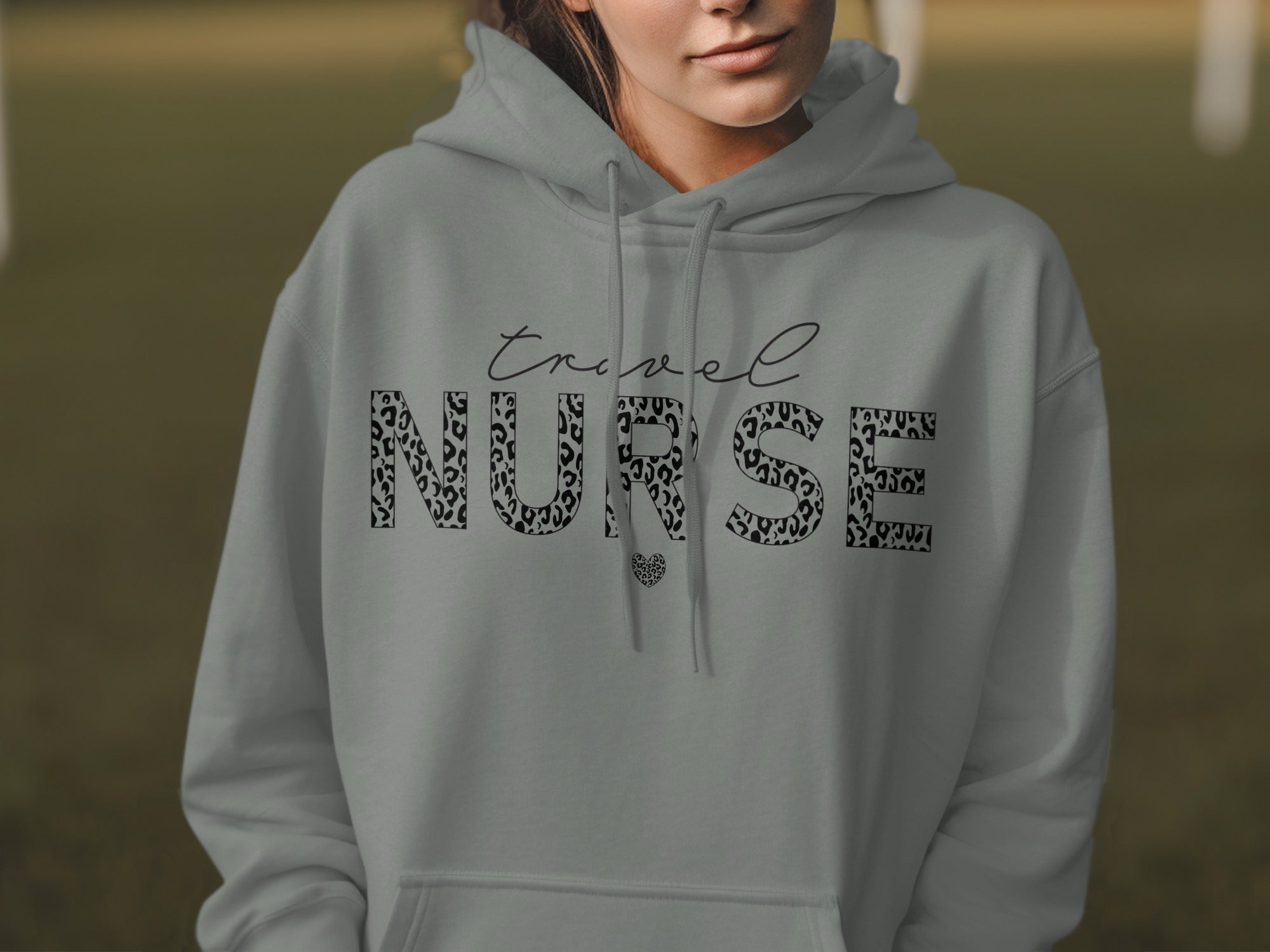 Grey hoodie with "travel NURSE" text in leopard print and heart detail.