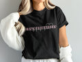 Black t-shirt with "Nurse Practitioner" text and a heartbeat line graphic.