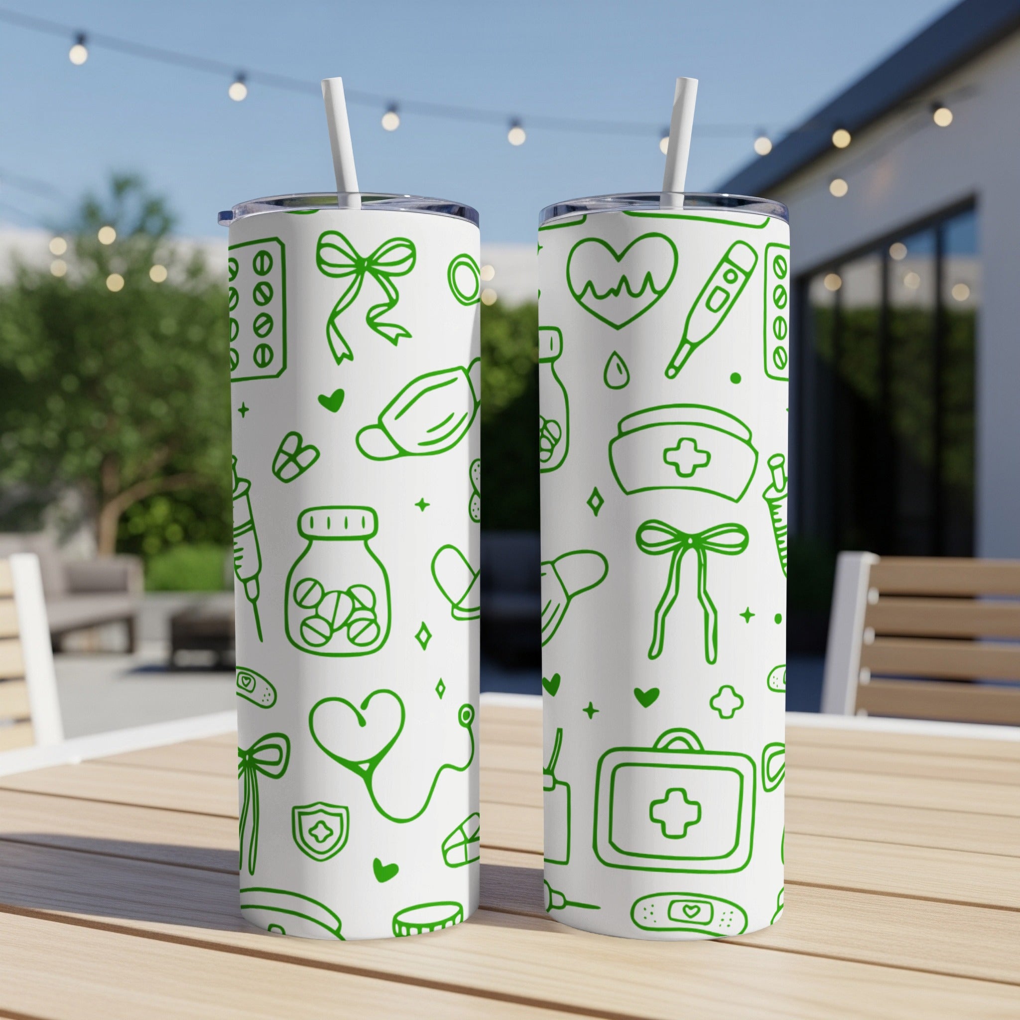 Two white tumblers with green medical-themed icons and patterns.