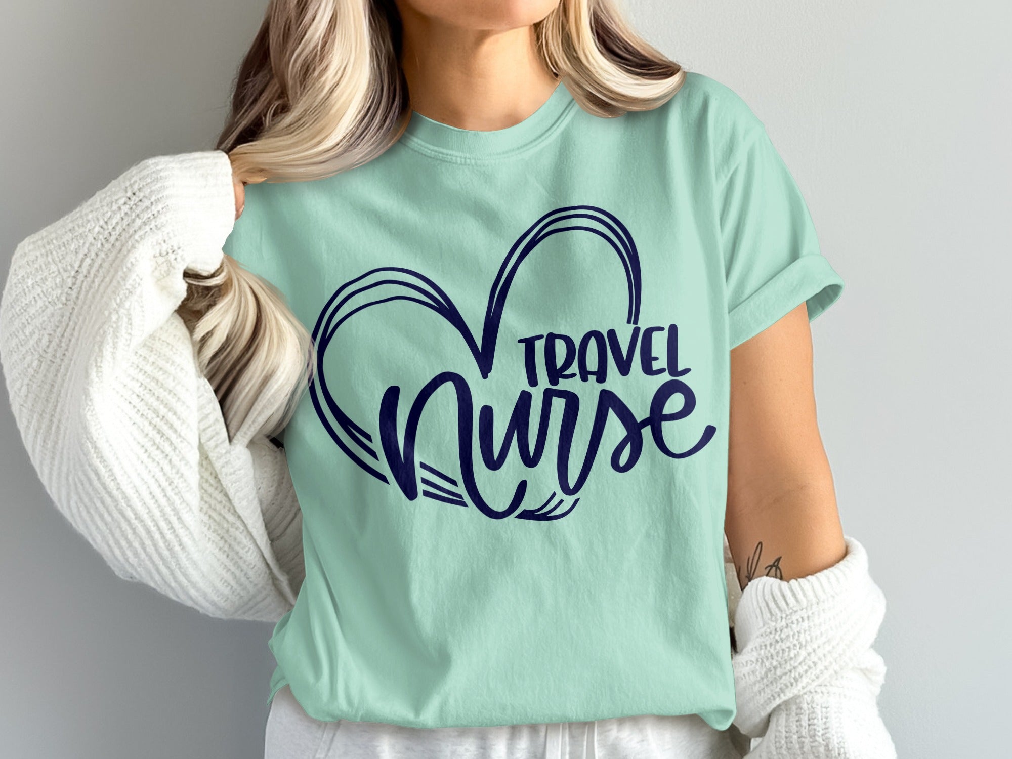 Mint t-shirt with navy blue heart and "Travel Nurse" text.