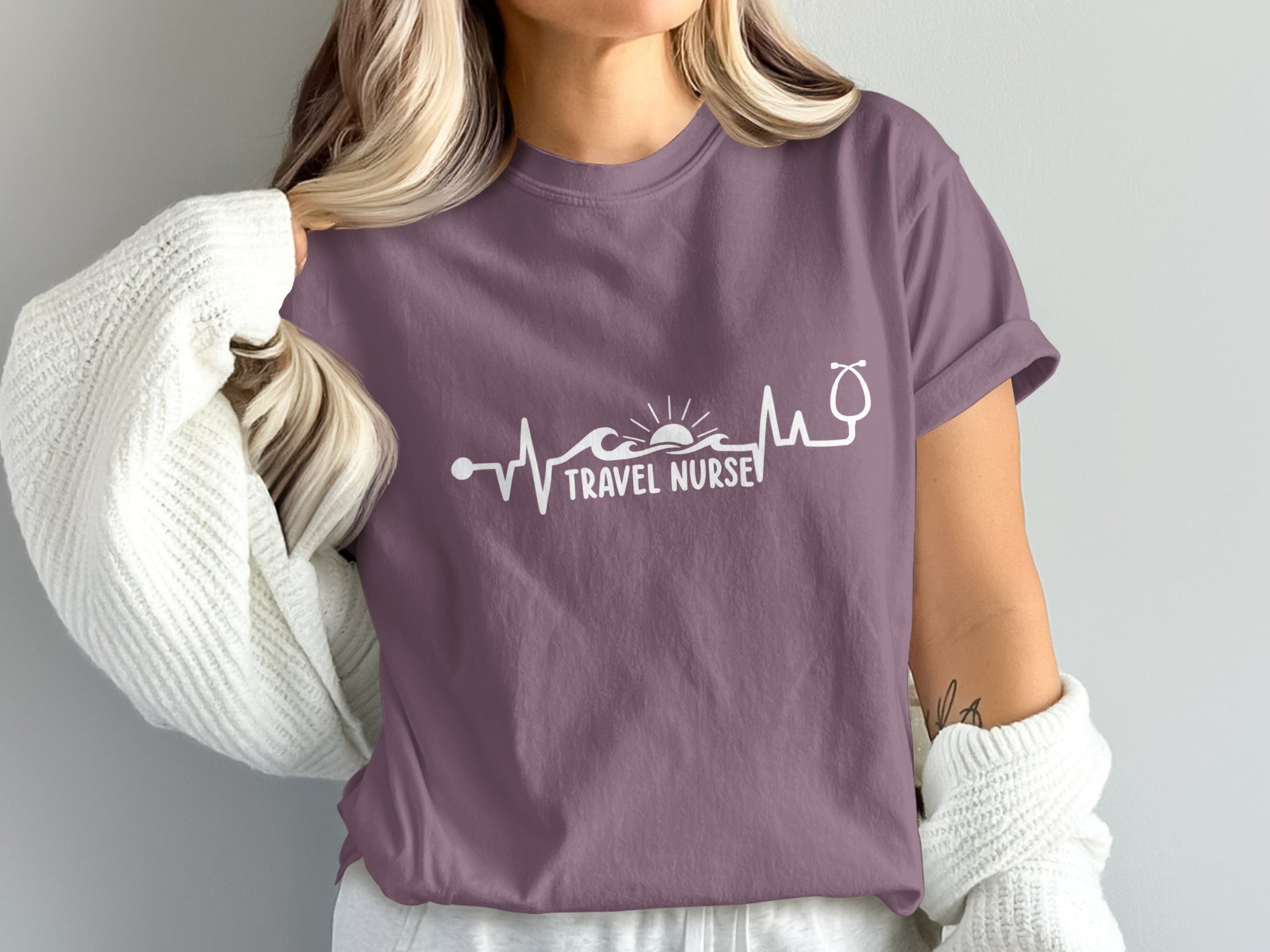 Purple t-shirt with "TRAVEL NURSE" and a stethoscope heartbeat graphic.