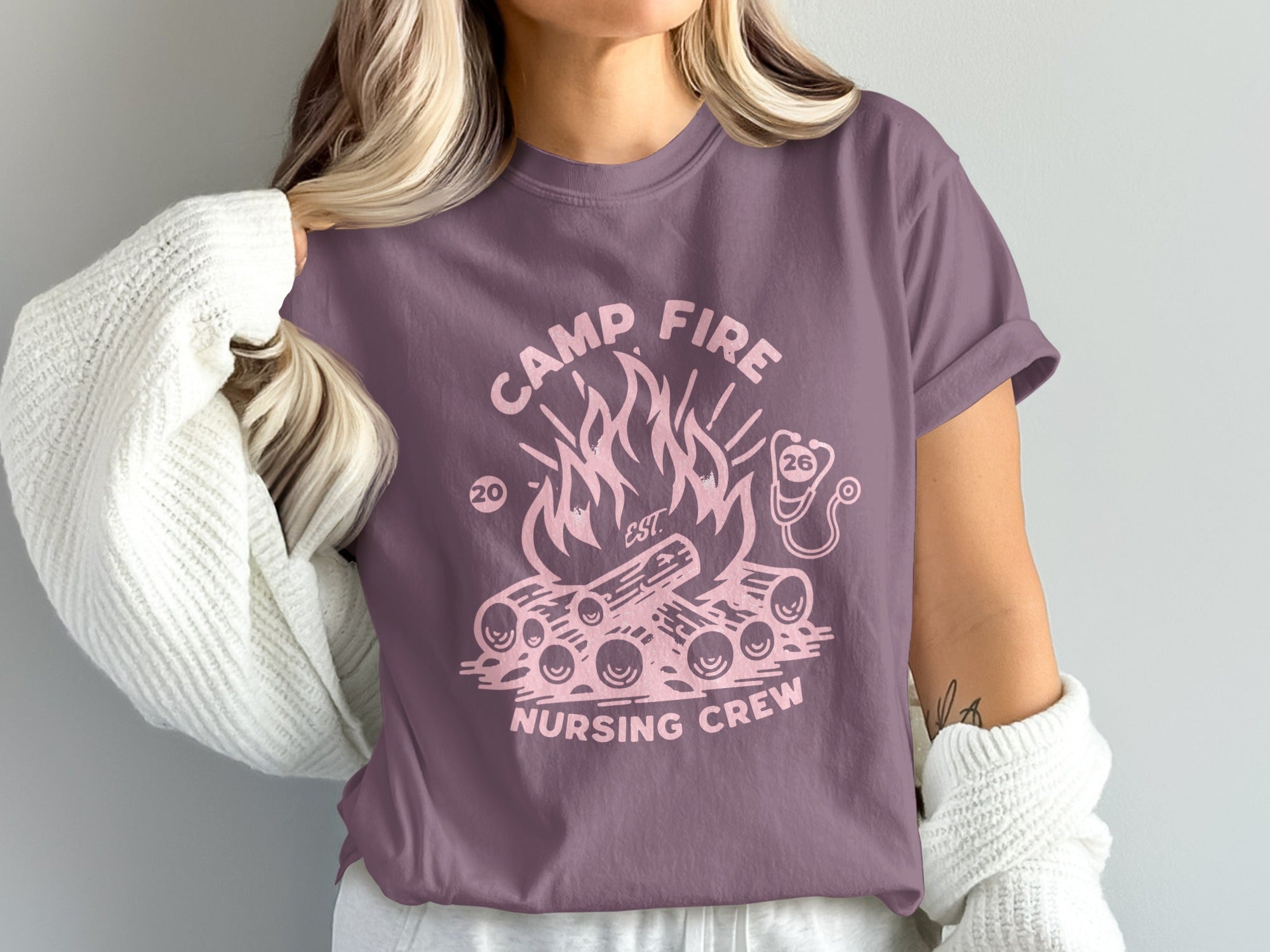 Camp Fire Nursing Crew graphic on a purple t-shirt.