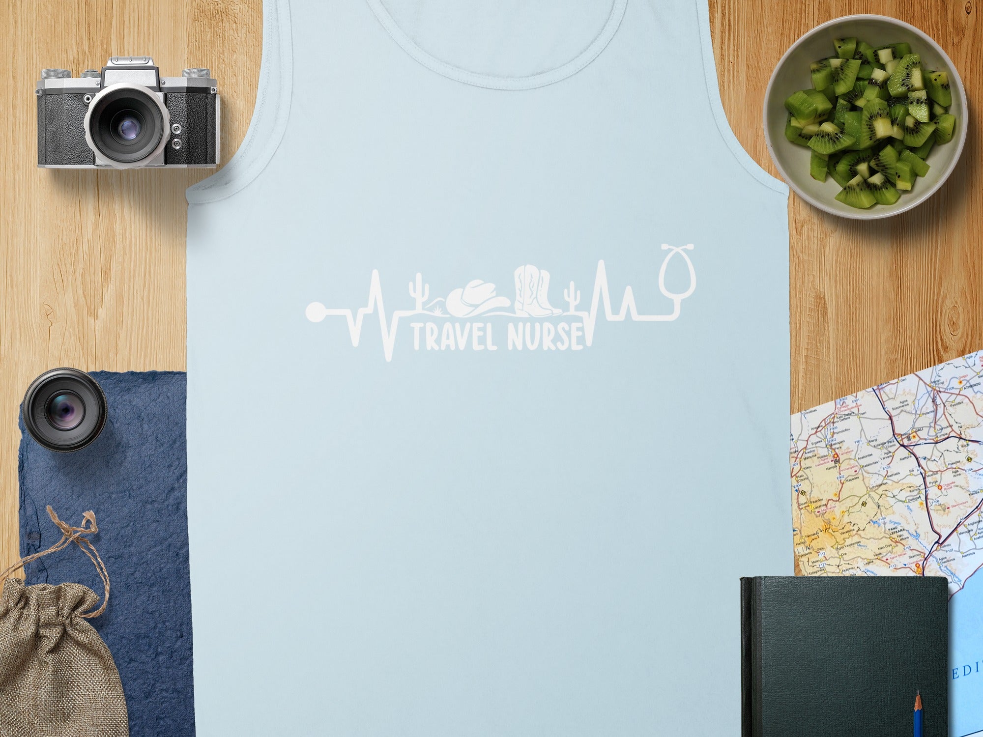 Light blue tank top with a white electrocardiogram design incorporating a stethoscope, cowboy boot, and cactus.