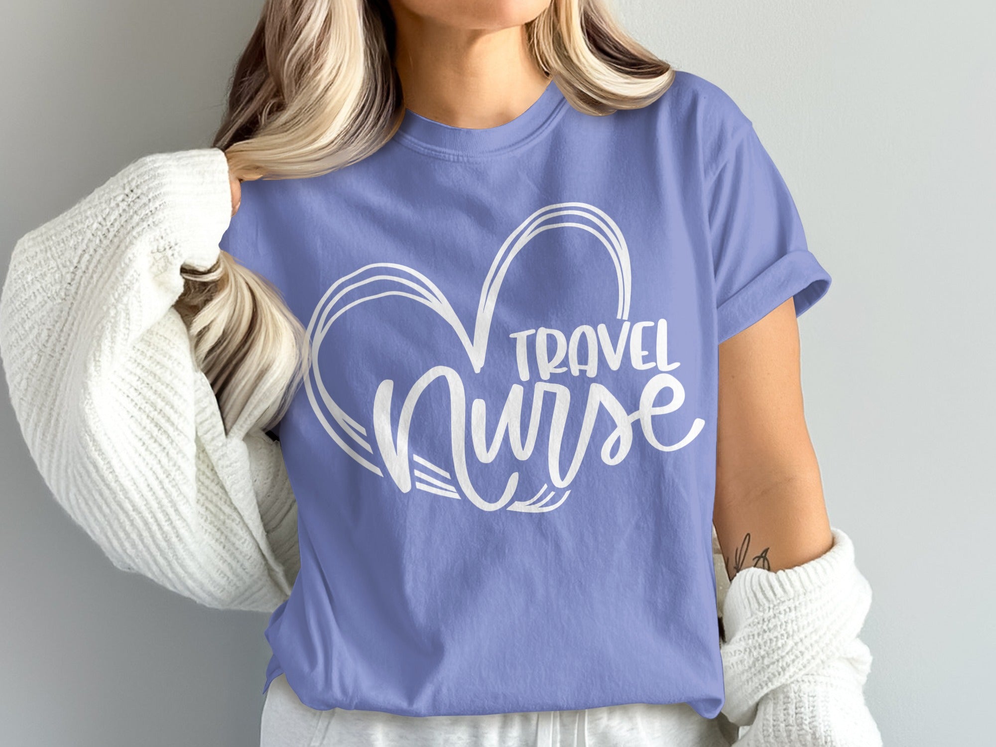 Purple t-shirt with white "Travel Nurse" text inside a heart outline.