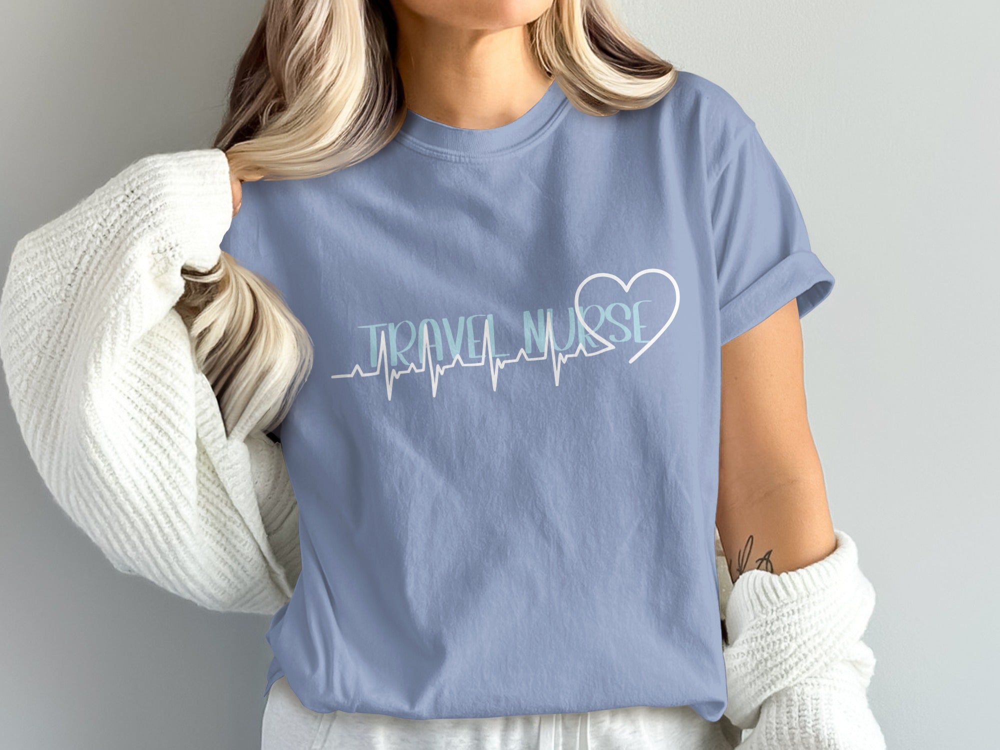Light blue t-shirt with "TRAVEL NURSE" and a heart with an EKG line.
