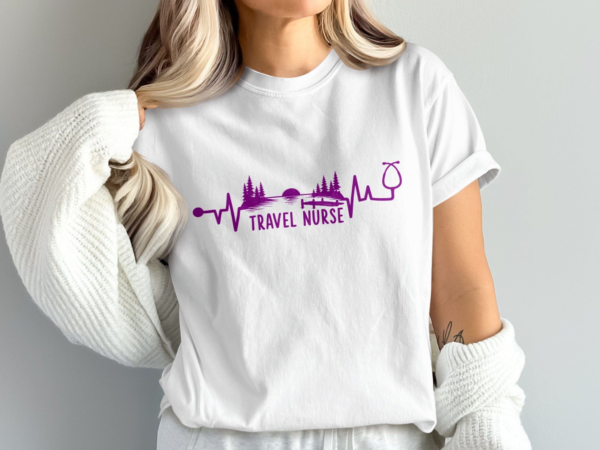 White t-shirt with purple stethoscope and mountain sunset heartbeat design.
