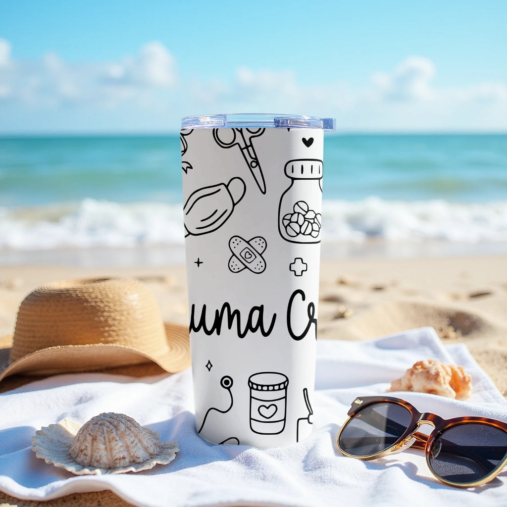 White tumbler with medical icons and text on a beach towel.