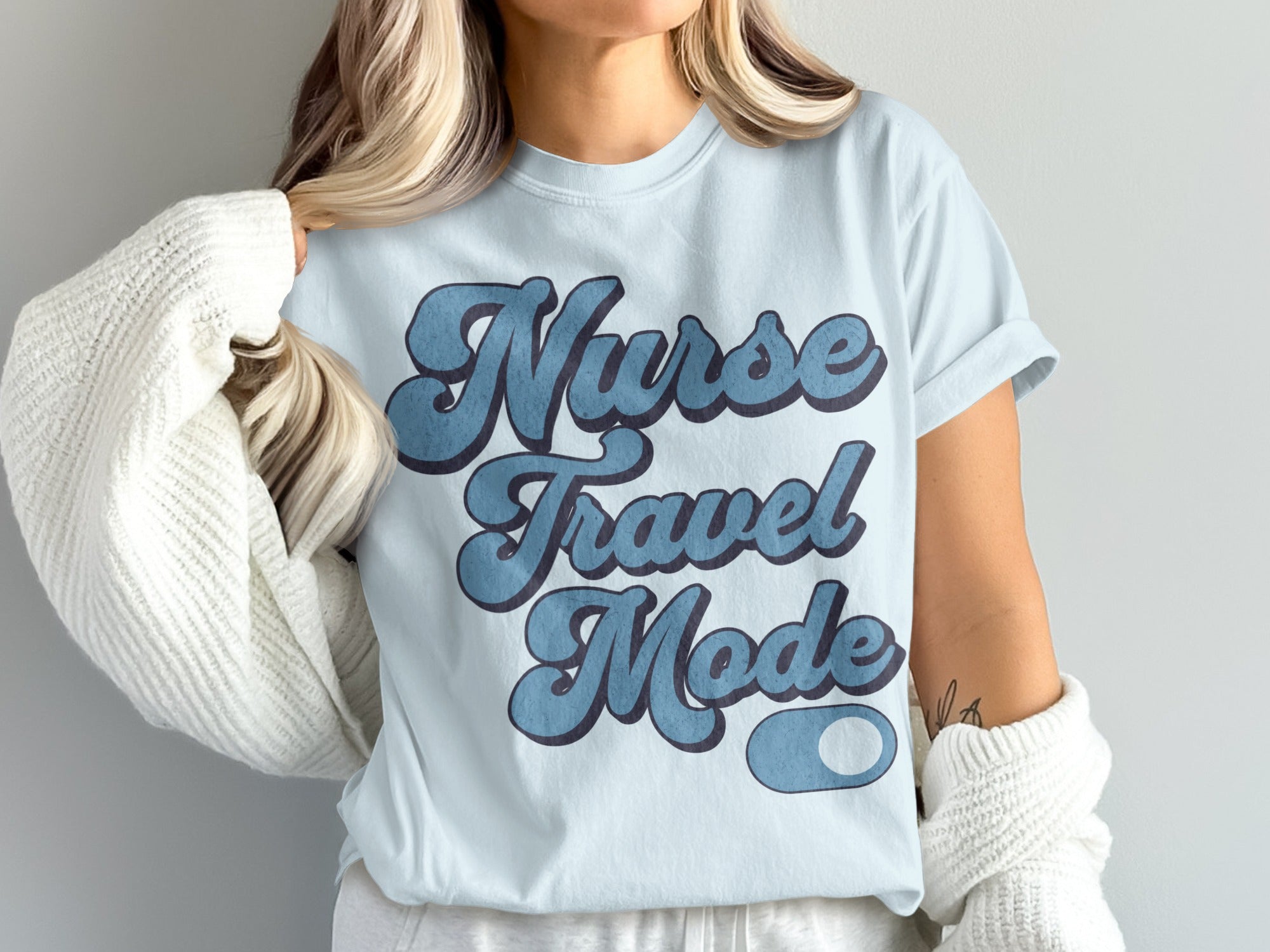 Light blue t-shirt with "Nurse Travel Mode" text in blue.