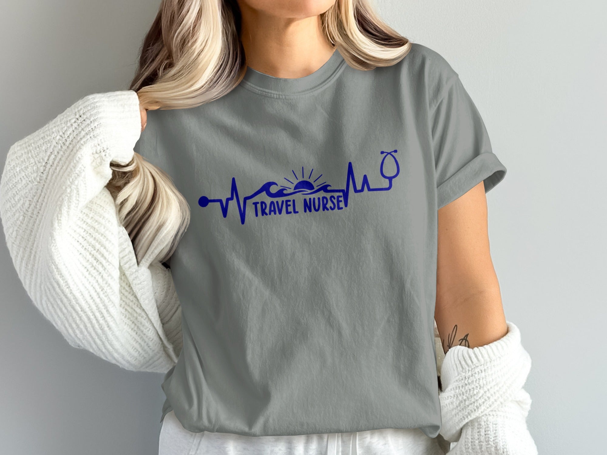 Grey t-shirt with blue heartbeat design, wave, sun, and stethoscope.
