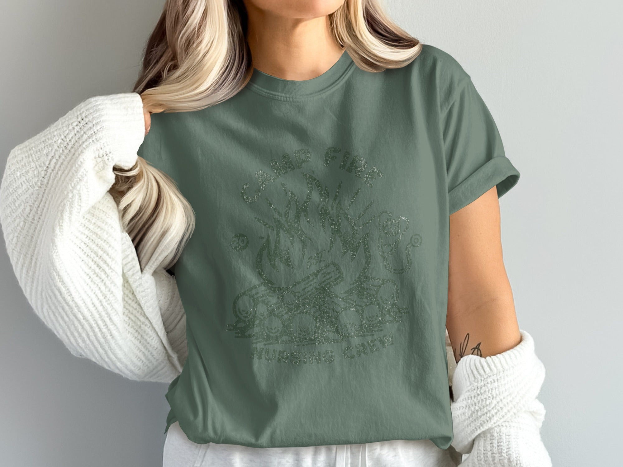 Green t-shirt with "CAMP NURSE" and campfire graphic.