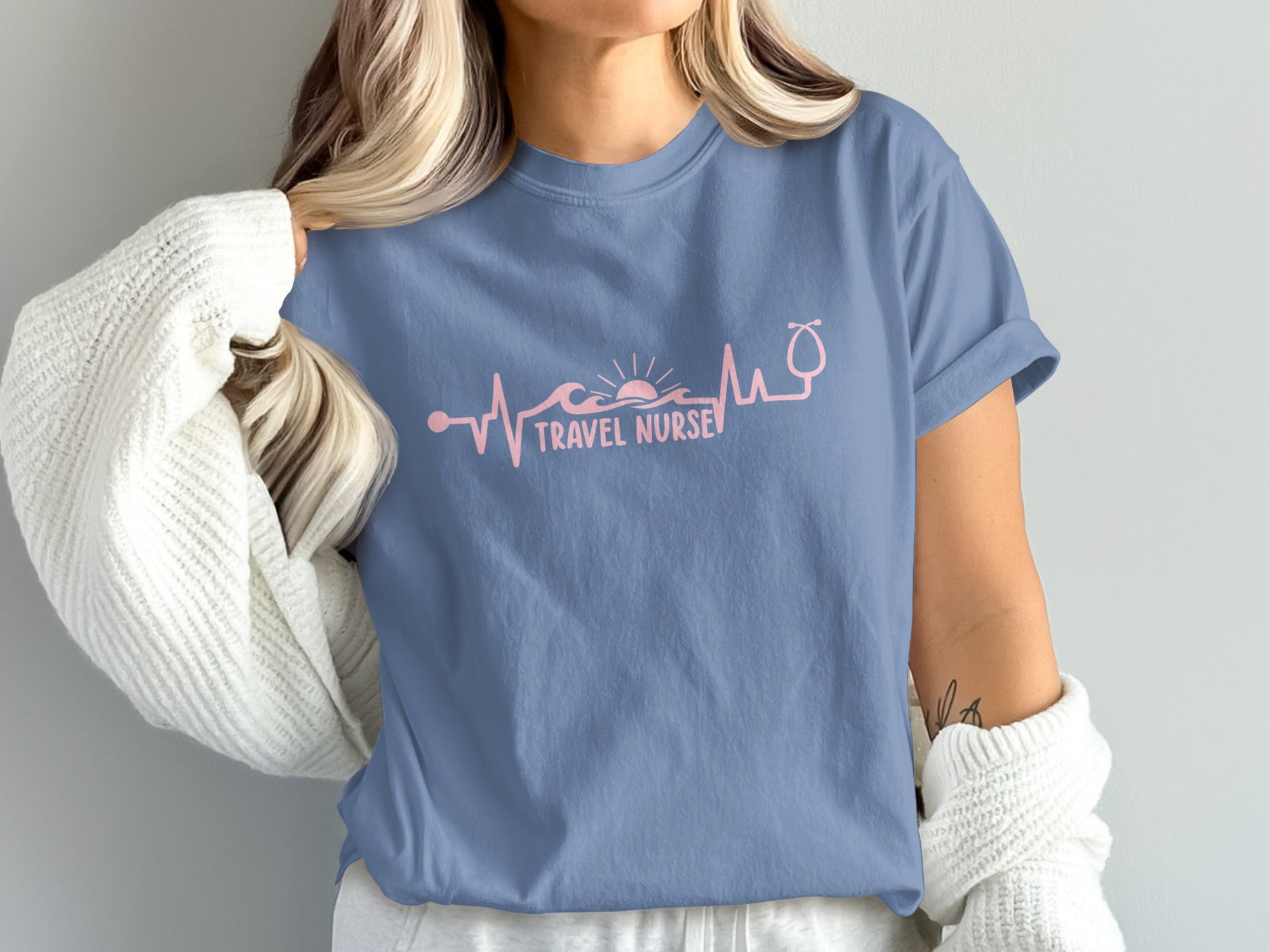 Blue t-shirt with "Travel Nurse" text, heartbeat line, and stethoscope.