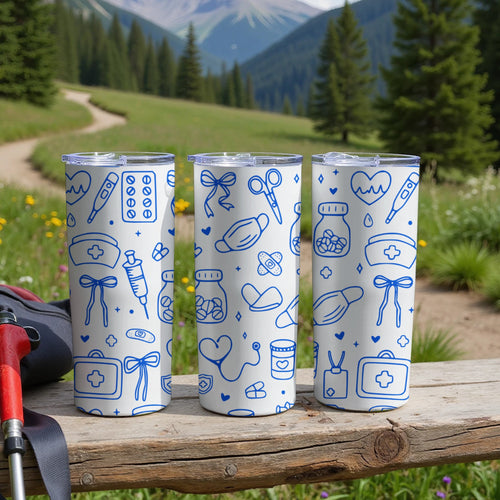 Three white tumblers with medical icons on a wooden surface outdoors.
