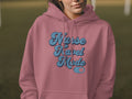 Pink hoodie with "Nurse Travel Mode" text in blue retro lettering.