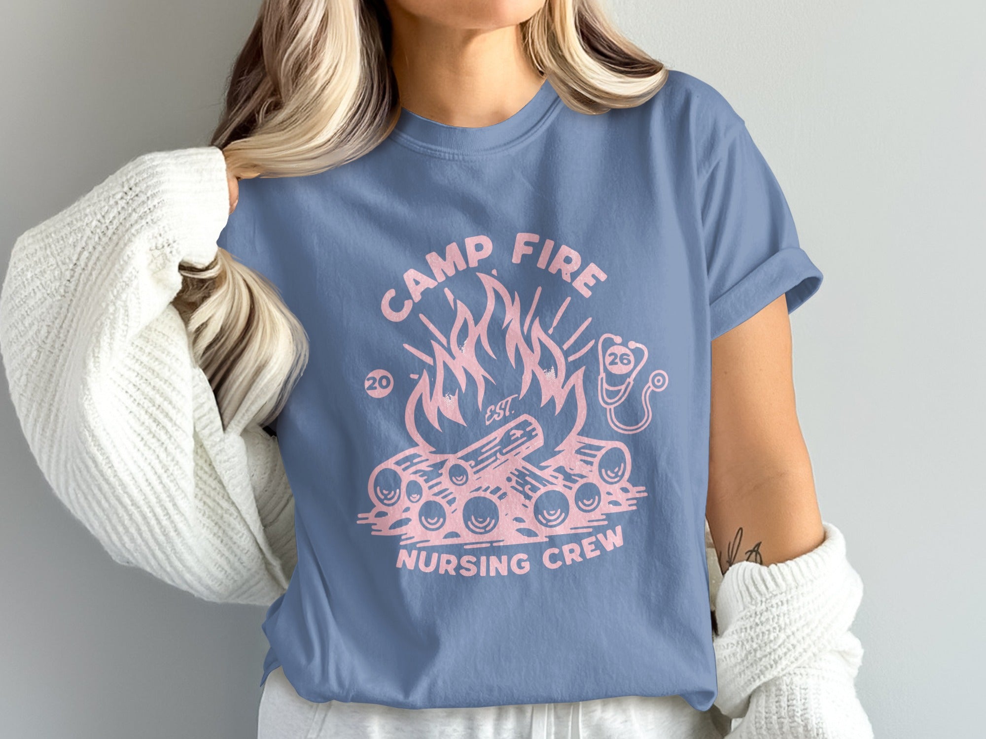 Pink campfire and "Camp Fire Nursing Crew" graphic on a blue t-shirt.
