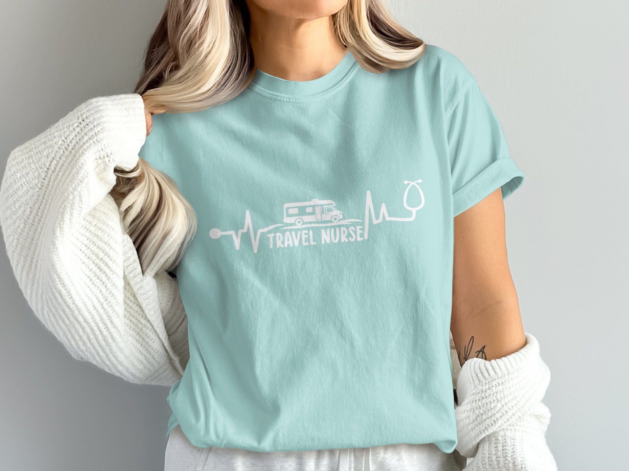 Light blue t-shirt with "Travel Nurse" text and RV/stethoscope heartbeat design.