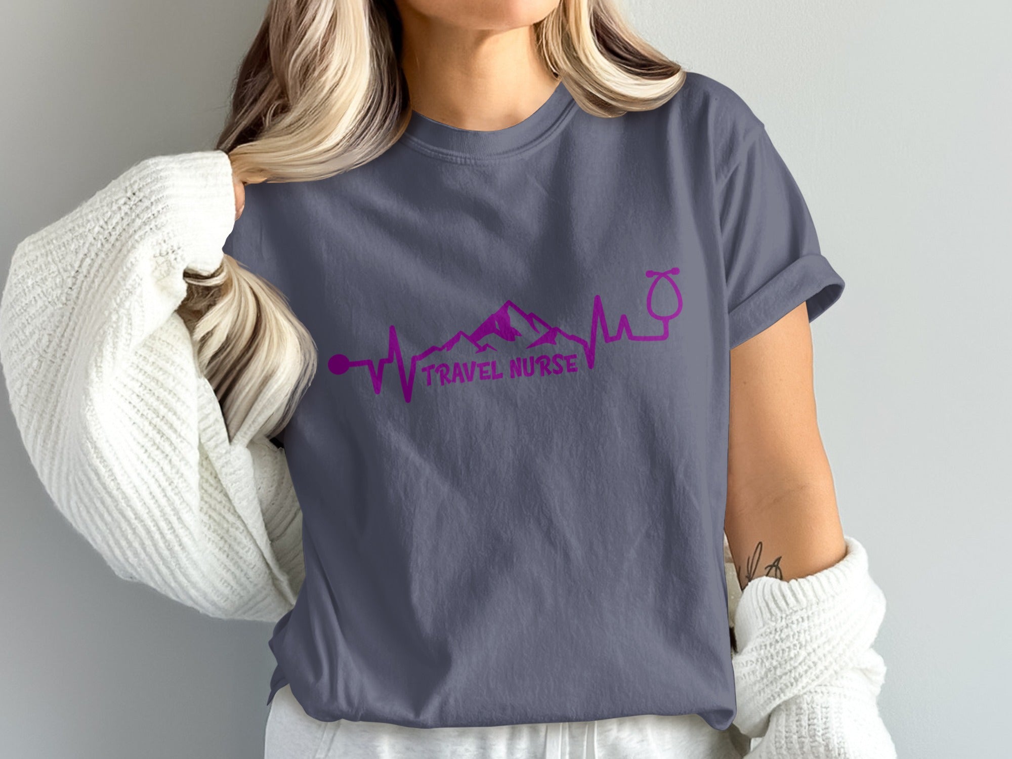 Purple t-shirt with pink travel nurse text and mountain heartbeat graphic.