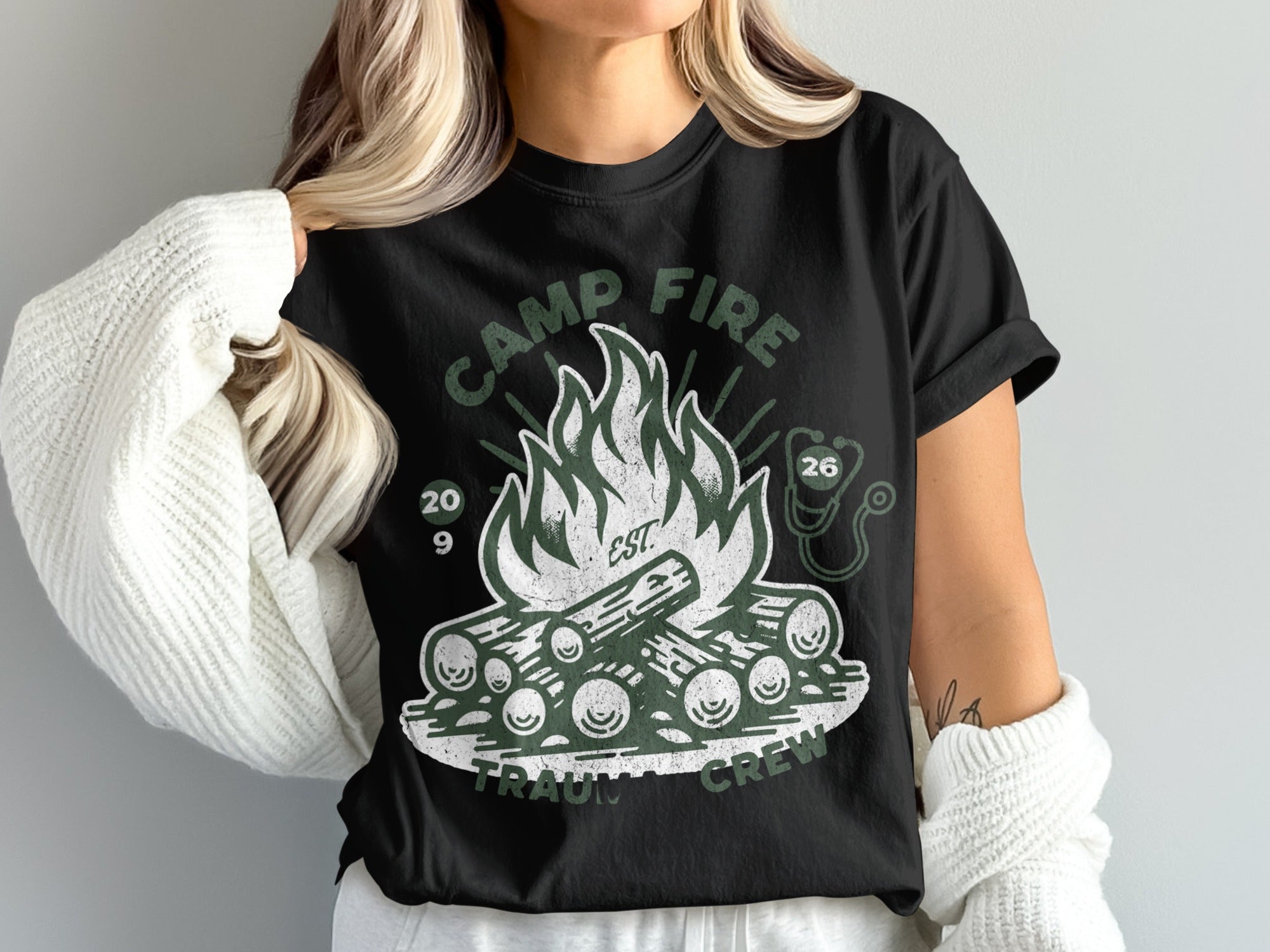 Camp Fire Trauma Crew graphic t-shirt with logs, flame, and stethoscope.