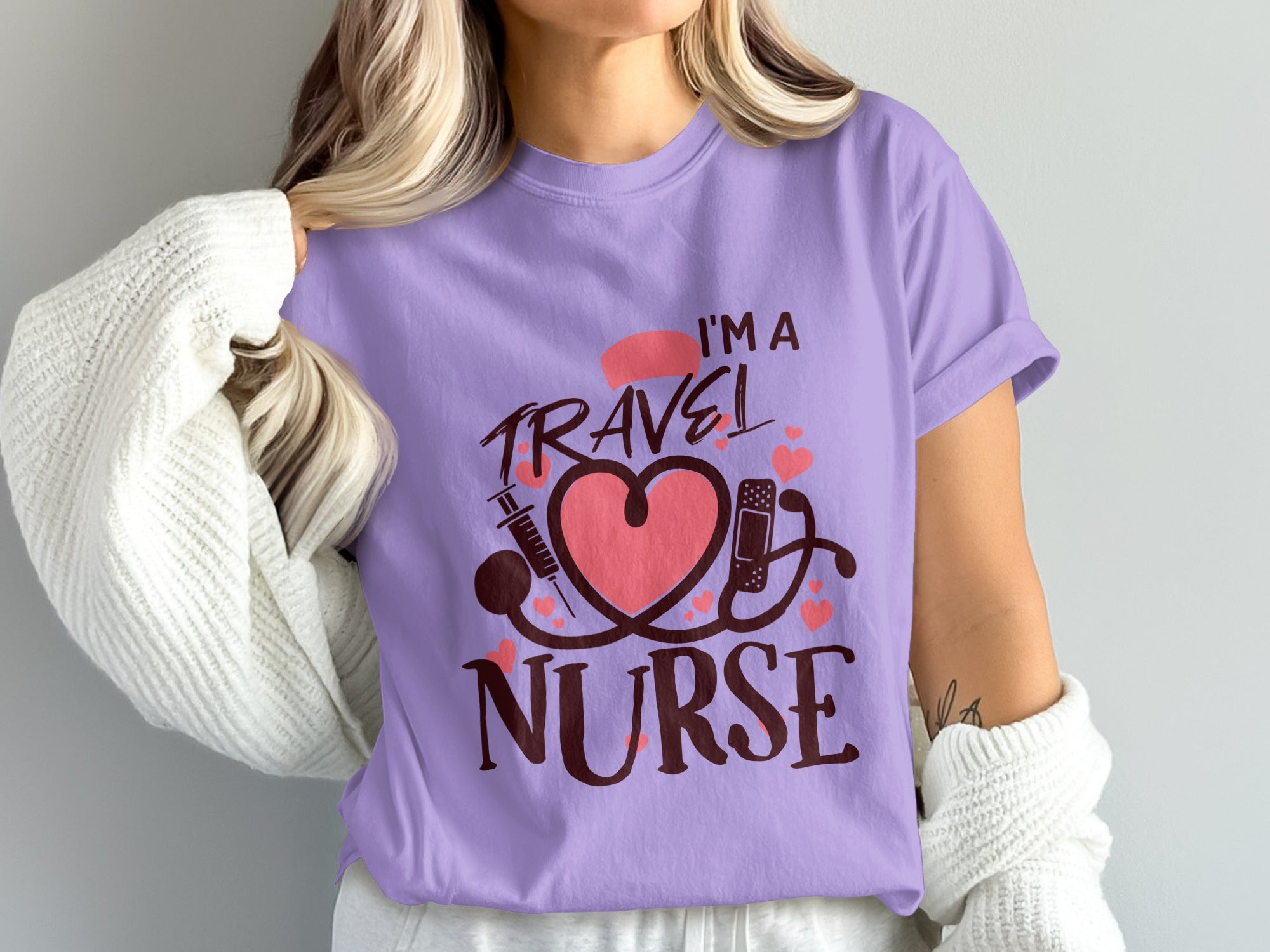 Lilac t-shirt with "I'm a Travel Nurse" text, stethoscope, heart, and syringe.