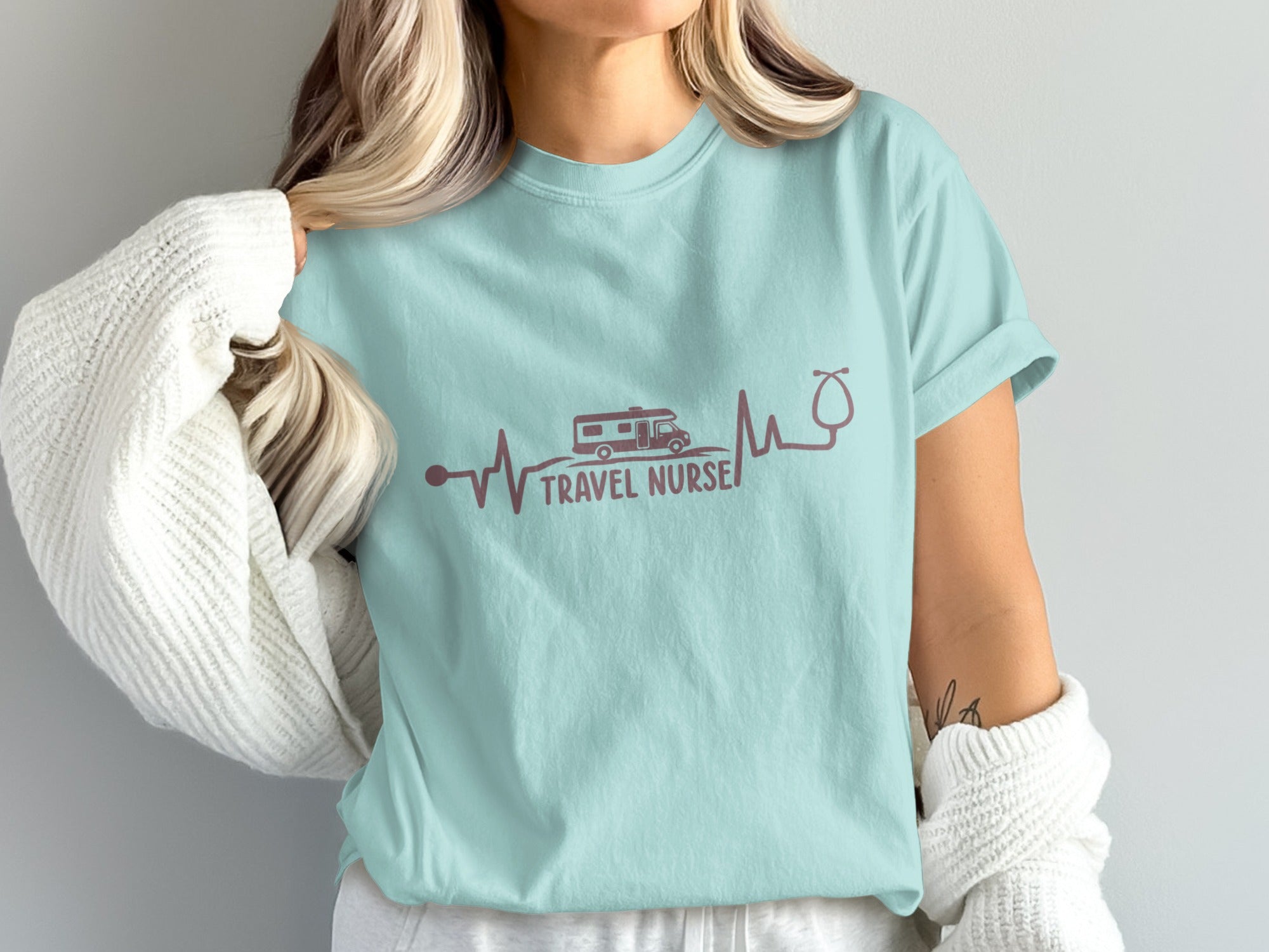 Light blue t-shirt with "Travel Nurse" text, RV, and stethoscope heartbeat graphic.