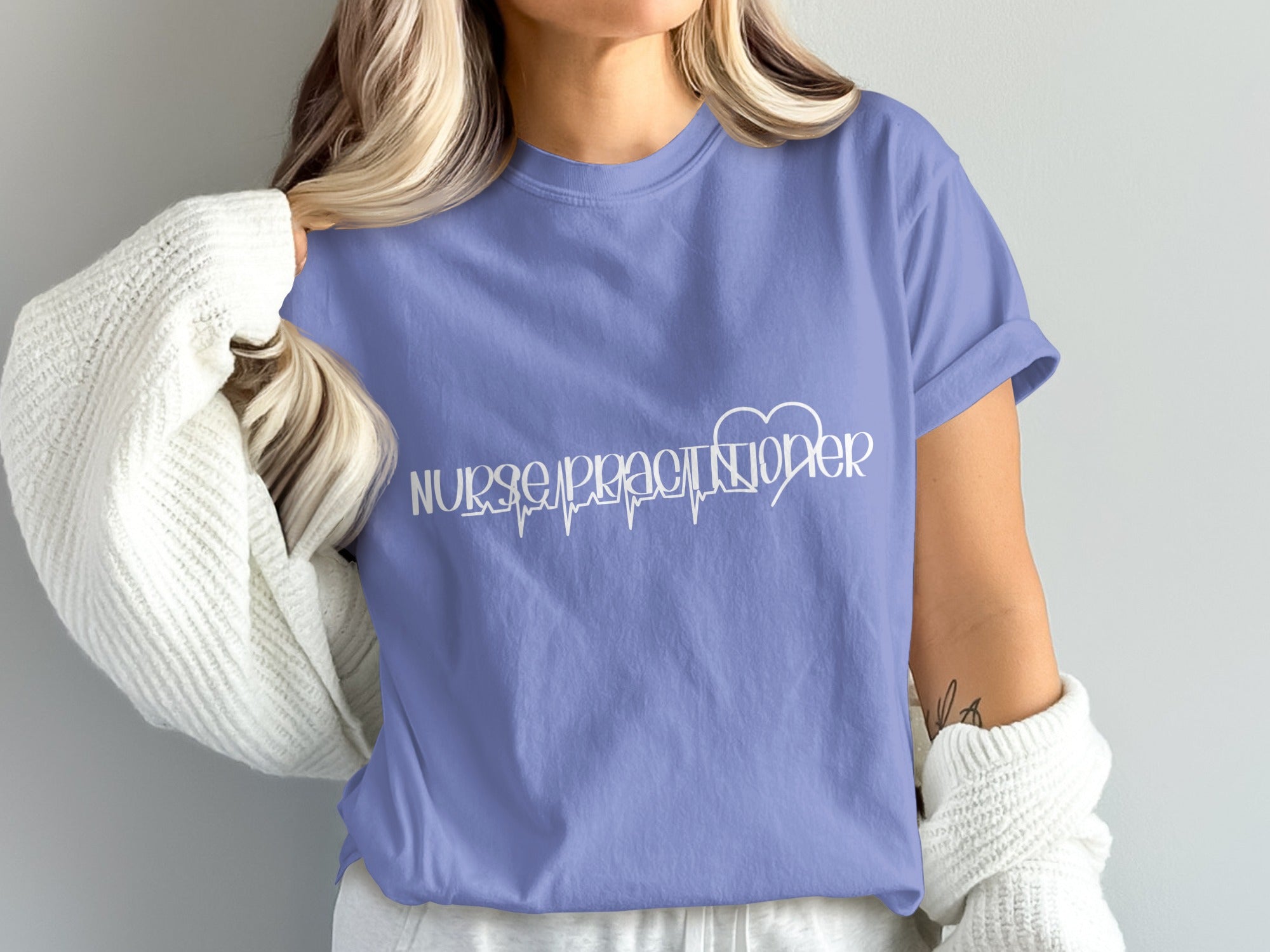 Periwinkle t-shirt with "Nurse Practitioner" and heartbeat graphic.